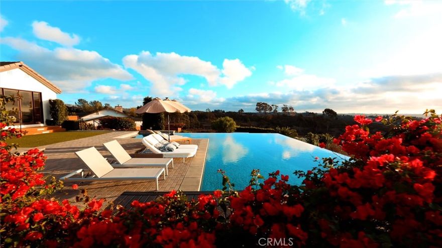 Discover a rare opportunity to own two modern single-story estates on one expansive lot in the highly sought-after 4S Ranch community. Designed with both luxury and independence in mind, each residence offers complete privacy with its own kitchen, driveway, garage, and laundry—perfect for multi-generational living or hosting extended guests in absolute comfort.

Floor-to-ceiling glass windows and panoramic sliding doors frame breathtaking sunset views, while a dramatic vanishing-edge pool creates a seamless connection between home and horizon. Thoughtfully equipped with solar power, these estates embody the perfect balance of contemporary elegance and sustainable living.

Inside the primary estate, soaring exposed wood-beam ceilings and an open floorplan establish a sense of grandeur, while custom fixtures and finishes elevate every detail. The chef’s kitchen is a centerpiece of design, featuring sleek quartz countertops, premium stainless steel appliances, and a Savant Home System for effortless smart living. With 5 bedrooms, 5.5 bathrooms, and 4,015 square feet of refined space, this residence offers unmatched sophistication and versatility.

The second estate enjoys its own private driveway, garage, laundry, and backyard—recently reimagined with a complete remodel inside and out. Totaling 2 Bedrooms, 1.5 bathrooms and 2,047 square feet, with bespoke fixtures, finishes, and a thoughtfully curated open floorplan, it offers both privacy and luxury in equal measure, making it ideal for distinguished guest accommodations or multi-generational living.

Together, these solar-powered estates embody the pinnacle of versatile living: a rare architectural masterpiece set against the backdrop of 4S Ranch’s most captivating vistas.