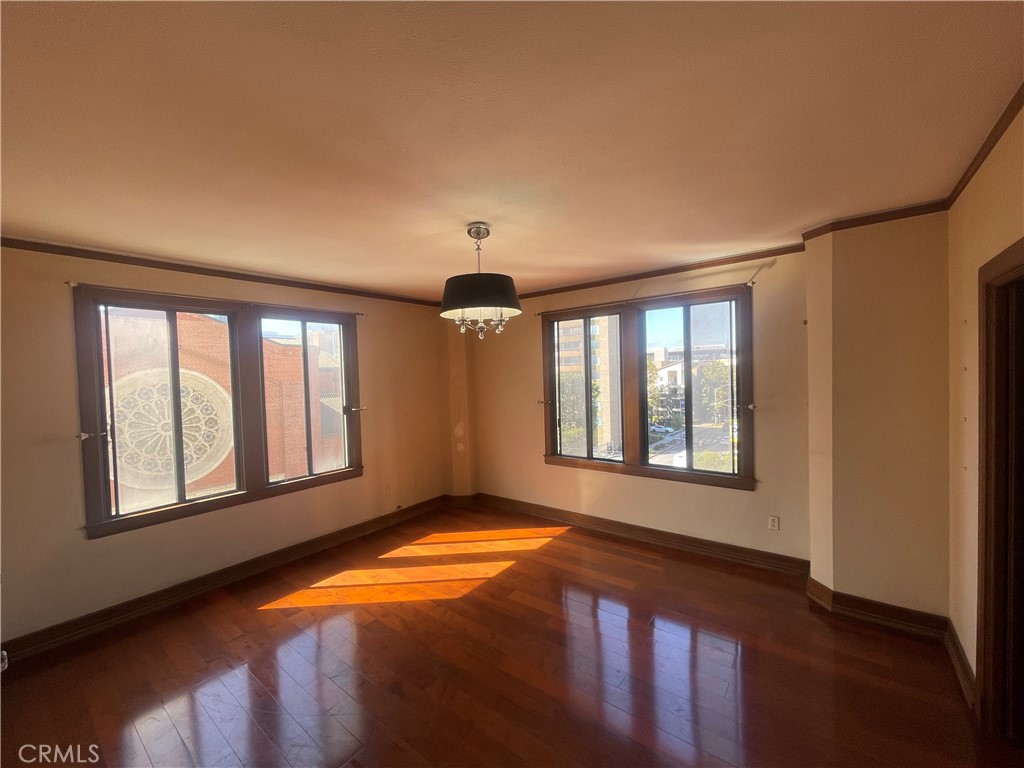 Rare opportunity to own a corner unit in the historic Willmore Building, offering breathtaking city views. This 1-bedroom, 1-bath condo features generous windows, natural light, and hardwood flooring that highlight its Italian Renaissance Revival character. Residents enjoy iconic amenities including a grand lobby, a furnished Solarium with 1920s charm, and a rooftop lounge with sweeping views of the ocean, city, and downtown LA. The acclaimed La Traviata restaurant is conveniently located on the ground floor. HOA dues cover all utilities except cable/internet. With its prime location near Ocean Boulevard, downtown shops, dining, nightlife, and easy access to the 710 freeway, The Willmore blends historic elegance with modern convenience.