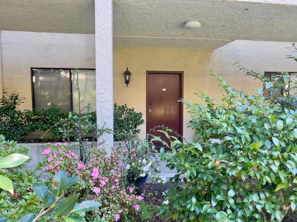 This charming, ground floor has a perfect floor plan and lots of space for all of your needs. With 2-bedroom, 2-bathroom occupying 1195 square feet, this one has it all! The well-appointed kitchen features granite countertops, an electric cooktop, oven, microwave, dishwasher, garbage disposal, and refrigerator, making meal preparation a breeze. In-unit laundry for convenience and a plethora of community amenities are just more reasons to love this home. The home boasts a combination of hardwood, laminate, and tile flooring throughout. The primary suite includes a retreat area and a walk-in closet, while the bathroom features double sinks and a full bath on the ground floor. Cozy up by the fireplace in the living space, which leads to a dining area perfect for family meals. Additional amenities include a walk-in closet, wet bar, and central AC for those warmer days. The community offers a pool, in-ground spa, steam room/sauna, and a gym. The property includes access to a secure parking garage & two assigned parking spots. This home is within the Santa Clara Unified School District. Don't miss out on this idillic location that's central to everything and yet feels like a private retreat.