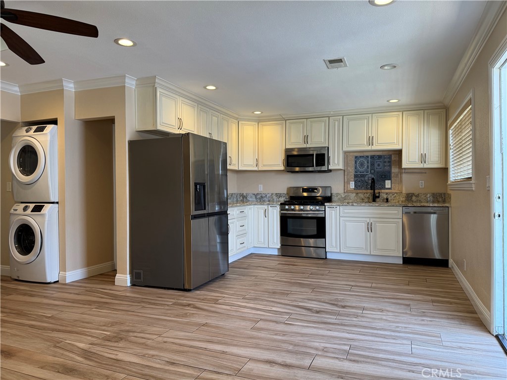 Spacious apartment home close to the beach features 2 bedrooms, 2 bathrooms, fridge/washer/dryer are included, 1 assigned parking space, street parking available, pet friendly breed and size restriction. Available for immediate move in. Rent includes utilities.
