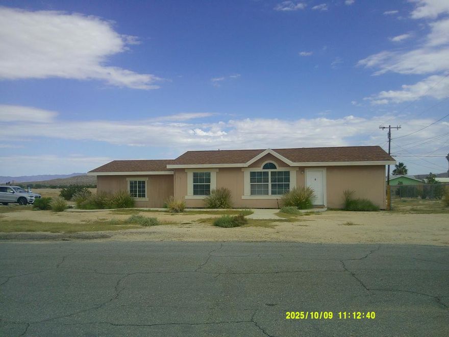 Nestled conveniently just east of Adobe Road and close to downtown, this meticulously cared-for 3-bedroom, 2-bath residence boasts over 1,100 sq ft of cozy living space, making it an ideal choice for families, first-time homebuyers, or anyone eager to embrace the high desert's charm. With a straightforward route to the Marine Corps Base via Adobe Rd, this property is perfectly suited for military members. Step inside to discover brand-new luxury vinyl plank flooring throughout, lending a fresh and contemporary vibe to each room. Central heating (natural gas) and air conditioning provide comfort in every season. The generous 2-car garage offers ample storage solutions, while the fully fenced backyard is perfect for pets, alfresco dining, or crafting your own serene retreat. Adventure awaits just a short drive away at the 29 Palms entrance to Joshua Tree National Park. Come and explore all that the park and the lively 29 Palms community have to offer! Seize this opportunity to claim this high desert treasure as your own..This is an mfg home on a permanent foundation  ( see tax rolls) and title company will insure.  This is eligible for all kinds of financing.  Bring   your VA and FHA  buyers