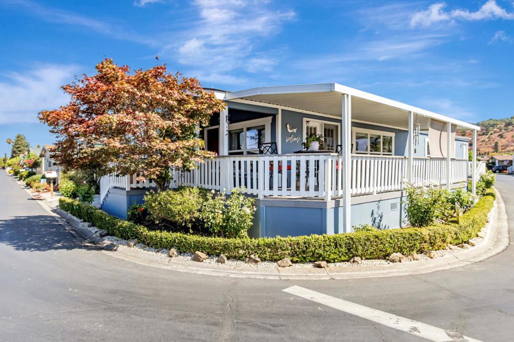 Pride of Ownership can be seen in both the aesthetics and the structural upkeep of this charming 3 bdrm, 2 bath, 1,643 sq ft home built in 2007. Located in the Blossom Hill/Almaden area of S.San Jose. Prime corner located in a FIVE STAR SENIOR community, Villa Teresa. The kitchen is a chef's or baker's delight, featuring granite countertops, an island, and modern appliances including a gas oven range and microwave. Newer French door refrigerator, dishwasher,A skylight brightens the kitchen, which includes a convenient breakfast bar. Very open kitchen and living room design. Warming gas fireplace. Large primary and guest bedroom. 3rd bedroom can also be an office or sewing room. Custom shades throughout the home. Laminate flooring. Primary bedroom with lg walk-in closet. Vaulted ceiling and energy-efficient dual pane windows. The laundry room comes equipped with a washer & dryer for added convenience. A huge Trex wrap around deck perfect for evening breezes and views of the hills. Low maintenance landscape. Carport parking for at least 2 cars. Villa Teresa offers it's residents a pool, spa, dog park, bocce ball and community garden. Billiards & ping pong. CORNER LOT location. Newer roof and water heater. Great space rent @ only $1316/mo thanks to San Jose City Rent Control.