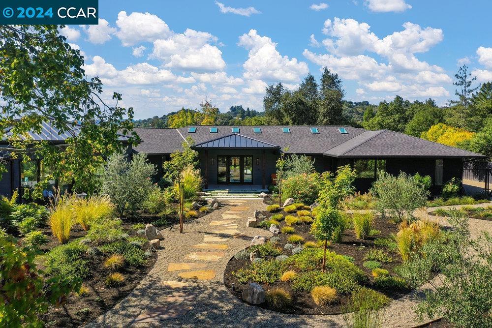 This meticulously maintained property was renovated in 2020 with an eye for design and craftsmanship. The spacious open floor plan is flooded with abundant natural light and ideal for both relaxing and entertaining. Step inside to the elegant Living Room with sweeping views of the hills, and sliding doors leading to an inviting patio and firepit. The Chef’s Kitchen gleams with a generous island, quartz countertops, custom cabinets, Sub-Zero Refrigerator/Freezer, 6 burner gas Wolf Range, Bosch dishwasher and beverage refrigerator. Continue to the show-stopping Great Room with two La Cantina folding doors, an impressive metal-clad gas fireplace, high ceilings and stunning views of the hills beyond the sparkling infinity pool and spa. Soak in the benefits of indoor-outdoor living, with walls of glass showcasing the gorgeous views from every living space. Enjoy your own private oasis, thoughtfully and professionally landscape-designed. Utilize the multiple outdoor seating areas which are perfect for al fresco dining and then enjoy the gas fire pit for after dinner conversation and relaxation. This home is minutes from top-rated Lafayette schools, hiking trails, downtown Lafayette, access to BART and highways 24/680.