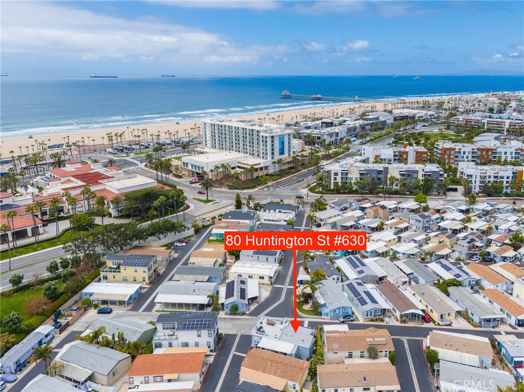 Across the street from the OCEAN!!! Welcome to your slice of paradise in the heart of Surf City USA. Nestled on a prime corner-lot less than a block from the sand, this stunning 2015 Fleetwood home offers an unbeatable blend of relaxed beachside living and modern luxury. With direct access through the back gate to the oceanfront, you’ll never have to travel far to live your dream with this is vacation living, every day of the year. Step inside and you’re greeted by soaring 9-foot ceilings and elegant crown molding. Rich bamboo hardwood floors add warmth and style, complementing the natural light through double-pane windows. This 3-bedroom, 2-bathroom home is as practical as it is beautiful, with one full bath and one three-quarter bath designed for comfort and convenience. The kitchen is a chef’s delight with a built-in pot filler, beverage fridge, and all modern appliances. A custom pantry provides plenty of storage, and recessed lighting throughout adds a contemporary touch. French doors off the master suite leads to your own private patio, where morning coffee meets ocean breezes. The master bedroom also features a spacious walk-in closet. Life here extends seamlessly outdoors with two separate patios, one upstairs and one down. Ideal for entertaining. The rooftop deck is a true sanctuary, offering views that stretch across downtown Huntington Beach, with over 624sqft of waterproof, and cool anti-slip deck area to party with friends. The deck is equipped with a water line, electricity, and propane connection perfect for a BBQ or cozy fire pit under the stars. The homes’ exterior is as well-maintained as the inside, with brand-new outdoor paint and gutters completed in February 2025. Waterproof enclosed front stairs provide both durability and style, while the professionally landscaped dog run with pet-grade turf makes this the perfect home for four-legged family members. Additional perks include built-in rear storage, a large, attached storage area, and covered parking with two carport spaces, great for storing your beach bikes and surfboards. Modern features such as a tankless water heater, central heating, and air conditioning ensure year-round comfort. Also enjoy the gated pool and spa only footsteps away. From your rooftop deck, enjoy thrilling flyovers during the Pacific Airshow, and 4th of July fireworks, and take in world-class events like the US Open. The Huntington Beach Pier is less than a mile walk. Space rent is only $3,700 a month.