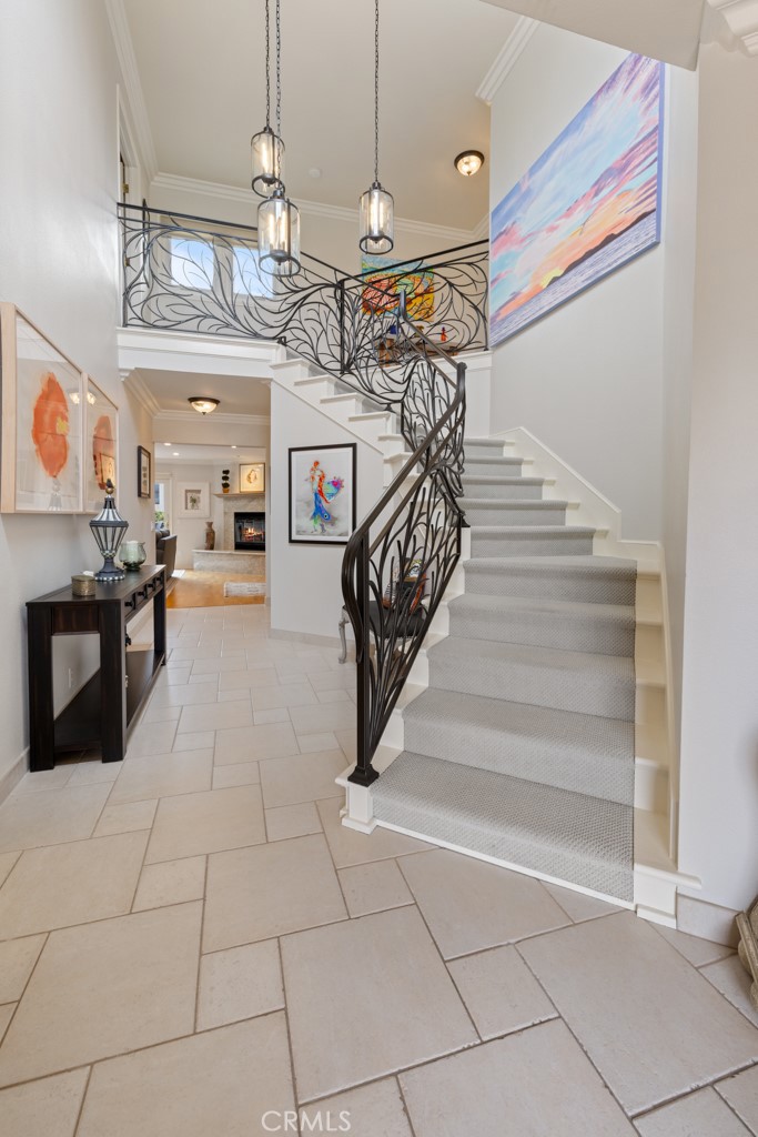 Custom Coastal Retreat in the Coveted Palisades of Capistrano Beach
Welcome to your dream home in the highly sought-after Palisades neighborhood of Capistrano Beach—where coastal charm, privacy, and custom design converge. This beautifully crafted residence offers the perfect blend of casual elegance and everyday comfort, just moments from the beach, Pines Park, and all that Dana Point has to offer.
Set on a spacious lot west of the 5 freeway, this thoughtfully designed home welcomes you with a dramatic vaulted entry, showcasing a custom wrought iron stair rail and timeless architectural details. Inside, you'll find an open-concept layout with vaulted ceilings, hardwood flooring, and crown molding throughout, enhancing the home's refined coastal aesthetic.
The inviting living room centers around a stunning granite fireplace, seamlessly connecting to the dining area and expansive chef’s kitchen. Designed for both entertaining and daily living, the kitchen features high-end stainless-steel appliances, a large center island with bar seating, custom cabinetry, and designer finishes throughout. Sliding doors open to multiple outdoor spaces, creating a seamless indoor-outdoor flow ideal for relaxed coastal living.
The downstairs primary suite is a private retreat with a spa-inspired bathroom, walk-in shower, and dual vanities—offering a peaceful place to unwind with added convenience and privacy. Additional bedrooms are generously sized, offering flexible options for guests, home office, or family needs.
The lushly landscaped backyard offers a serene escape with fruit trees, a fire pit, multiple patios, and ample room for entertaining, gardening, or simply enjoying the peaceful surroundings. An oversized two-car garage and expanded driveway provide plenty of parking and storage.
No HOA and no Mello-Roos means you’ll enjoy more freedom and fewer ongoing costs all in one of Dana Point’s most desirable coastal neighborhoods. Just minutes from local surf breaks, the harbor, hiking trails, and the vibrant Lantern District, this home provides the very best of Capo Beach living.