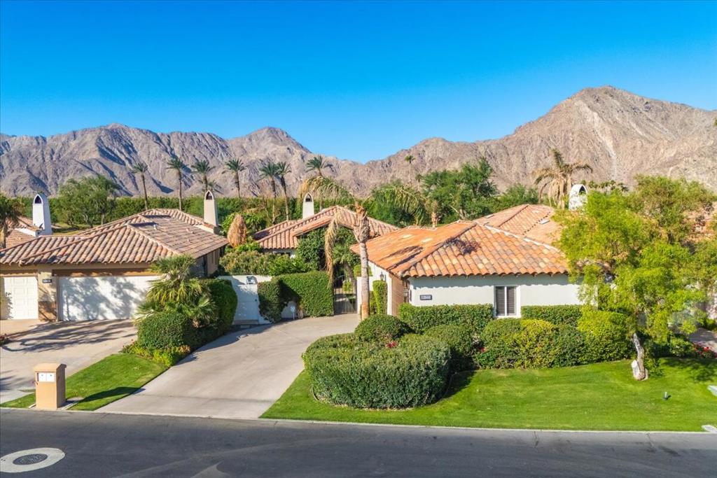 Available beginning November 2025 and throughout the 2026 season, this exquisitely renovated and furnished home is nestled within the highly sought-after Rancho La Quinta Country Club. Step into a world of sophisticated desert living, where every detail has been thoughtfully curated for a premier lifestyle experience, including high-end Restoration Hardware furniture throughout. The main residence features a master bedroom with a king-size bed and an en-suite bath, as well as a guest room with a queen-size bed and its own private bath. A large, private, detached casita with a king bed and full bath provides a perfect, secluded space for guests. The seamless fusion of indoor-outdoor living extends to the comfortable patio, which includes plenty of seating, a separate bar, an outdoor gas BBQ, and a soothing water feature. This private sanctuary offers stunning views of the Santa Rosa Mountains and the lush 5th fairway of the Jones Course. For your convenience, one of the community's nine pools and spas is located directly across the street. Centrally located, this home is just minutes from Old Town La Quinta, El Paseo, and the Indian Wells Tennis Gardens. This is more than a lease; it is your gateway to an unparalleled seasonal escape in a community renowned for its luxury, amenities, and timeless appeal.