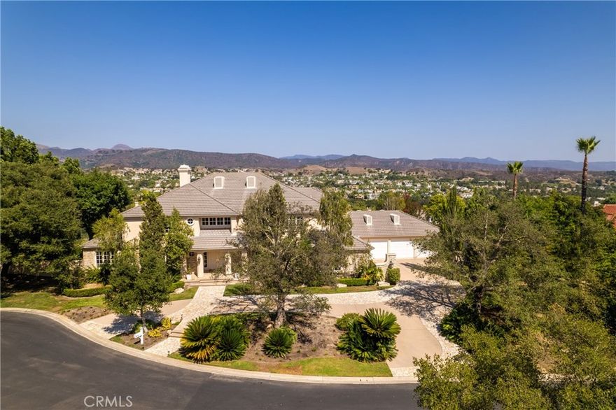 Welcome to 4 Arabian, a 6,500± sq. ft. custom estate tucked within the prestigious guard-gated community of Coto de Caza. This exceptional residence sits on 1 acre & offers 6 generously appointed bedrooms, 6.5 bathrooms, & an unparalleled blend of sophistication & comfort complemented by panoramic views. A sweeping circular drive introduces the property, framed by mature landscaping that sets a tone of timeless elegance. Upon entry, the grand foyer reveals soaring two-story ceilings, an abundance of natural light, & breathtaking views of rolling hills, the Saddleback Mountains, & the Coto de Caza Golf Courses. Every room in the home enjoys a view. The formal dining room & the inviting living room—anchored by a fireplace—create warm yet refined gathering spaces. Conveniently located off of the dining room is a butler’s pantry with plenty of storage & counter space.  The chef’s kitchen features an expansive center island, Sub-Zero refrigerator, double ovens, & a spacious walk-in pantry with an additional Sub-Zero refrigerator. It seamlessly flows into the light-filled family room, where a wall of windows frames the picturesque scenery. The dedicated home office is outfitted with custom built-ins & French doors to the yard. A versatile downstairs bonus room serves perfectly as a theater, game room, or private den. A large downstairs bedroom with full bath provides convenience for guests, complete with direct backyard access. The laundry room, with its own shower, is thoughtfully designed for both utility & ease. Ascending the main staircase, the primary suite is a private sanctuary boasting a cozy fireplace, a spacious flex retreat, dual spa-inspired bathrooms, and two expansive walk-in closets. Four additional upstairs bedrooms—three with walk-in closets & two with private ensuites—provide generous accommodations. A charming second-level porch spans the length of the home & showcases sweeping 180° views. The backyard is a true entertainer’s paradise with an expansive lawn, resort-style pool & spa, built-in BBQ & island, & lush gardens that create an idyllic setting for gatherings while boasting privacy from all sides. Parking is abundant, with two oversized garages offering 5 parking spaces, a separate storage room, ample built-in cabinetry, & a whole house water filtration system—plus additional parking in both the front circular drive & rear motor court. Located within the highly sought after enclave of The Woods, 4 Arabian is a timeless beauty.