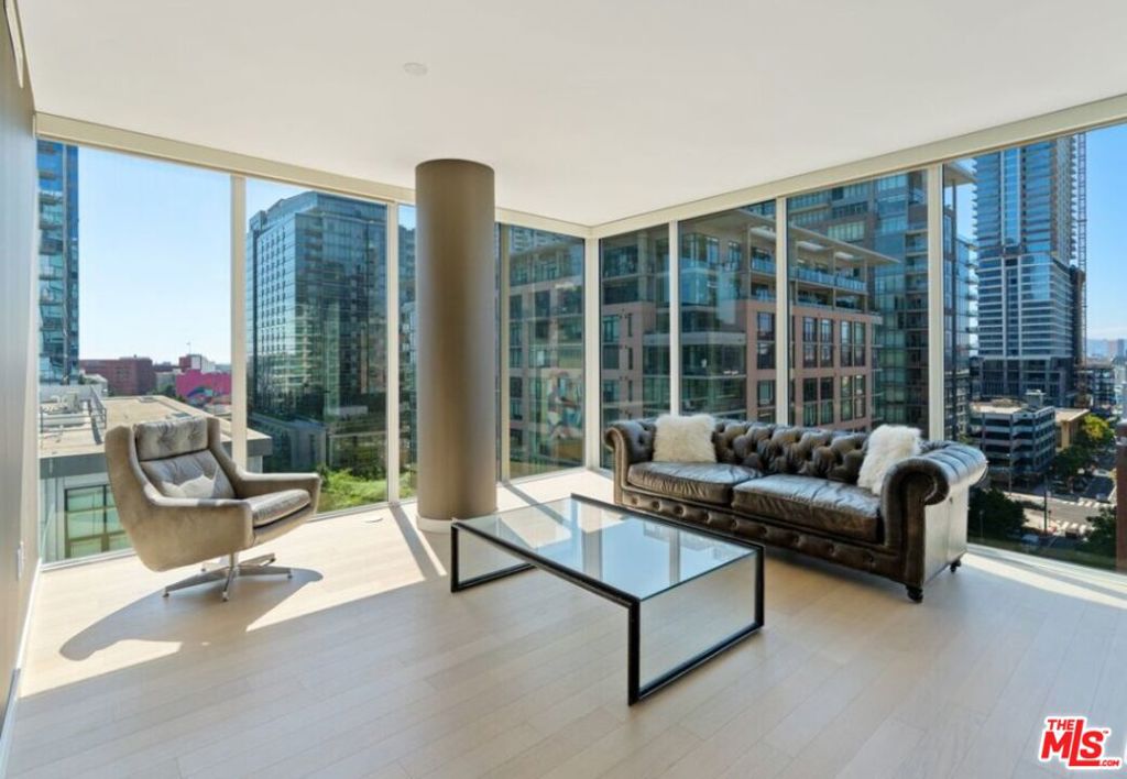 Experience luxury living in this remarkable corner home boasting dramatic floor-to-ceiling windows with sweeping panoramas of South Park and the iconic Downtown L.A. skyline.The stunning chef's kitchen features an oversized marble-topped island, sleek soft-close Domus & Domus Italian cabinetry, brilliant Carrara marble countertops and backsplash, and premium Bosch and Liebherr stainless-steel appliances.The primary suite is drenched in warm southwestern light and showcases expansive floor-to-ceiling windows, a generous walk-in closet with custom built-ins, and a spa-inspired en-suite bath with dual-sink quartz vanity, richly tiled porcelain walls and floors, and a chic walk-in shower.On the opposite wing, a private guest bedroom offers dramatic views toward L.A. Live, its own large walk-in closet with new cabinetry, and easy access to a full guest bath.Additional upgrades include motorized roller shades throughout, an LG all-in-one washer/dryer, Nest smart thermostat, and select Restoration Hardware furnishings. Two assigned parking spaces and partial utilities are included.At Ten50, enjoy resort-style amenities: an infinity-edge pool and spa, fire pits, barbecue grills, state-of-the-art fitness center, resident lounge with full kitchen and formal dining room, business center, media screening room, 24-hour security and concierge, plus rare guest parking. All this just steps from L.A. Live, Crypto Arena, Metro lines, and the city's most celebrated dining, shopping, and entertainment.
