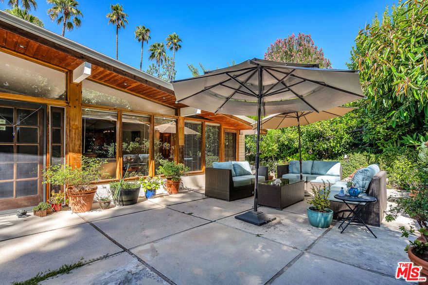 Serene Mid-Century escape with soaring architectural ceilings, located south of Ventura Blvd in Sherman Oak Hills and just minutes to the Westside, Mulholland's private school row, and in the desirable Roscomare Road Elementary district.  This 3-bedroom, 2-bath home spans approx. 2,400 sq ft and is filled with natural light and greenery views from every room. Features include a formal living room, cozy family room, open kitchen with new appliances, center island, breakfast counter, and a formal dining area. A bonus room off the family room is perfect for an office, gym, or creative space. Behind the kitchen, find a convenient laundry area, pantry, and extra storage.  AC unit and roof and solar panels are also new. Another standout feature is the exceptional quietness despite the home's proximity to the 405 freeway.  The backyard is a private retreat with thoughtfully designed landscaping and lush greenery, an ideal setting for peaceful outdoor living. For peace of mind, the home is equipped with an alarm system and Ring camera. This home combines timeless design, modern updates, and a rare sense of tranquility- truly a special one!