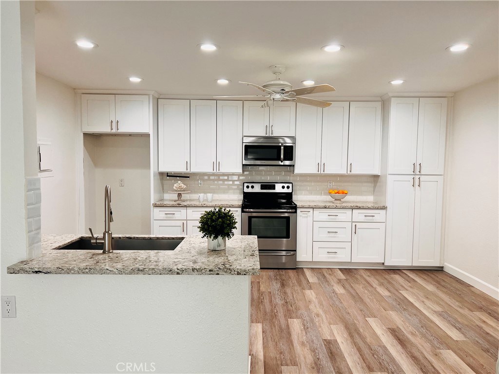 This lower unit home features 2 bedrooms and 2 baths, with beautiful vinyl floors, quartz countertops, new shaker cabinets, newer appliances, fully remodeled showers, new window coverings and freshly painted. Complex features volleyball court, tennis courts, a fitness center and a pool. Community laundry is very close to the unit. Very close in proximity to the 55 and the 5 FWY.