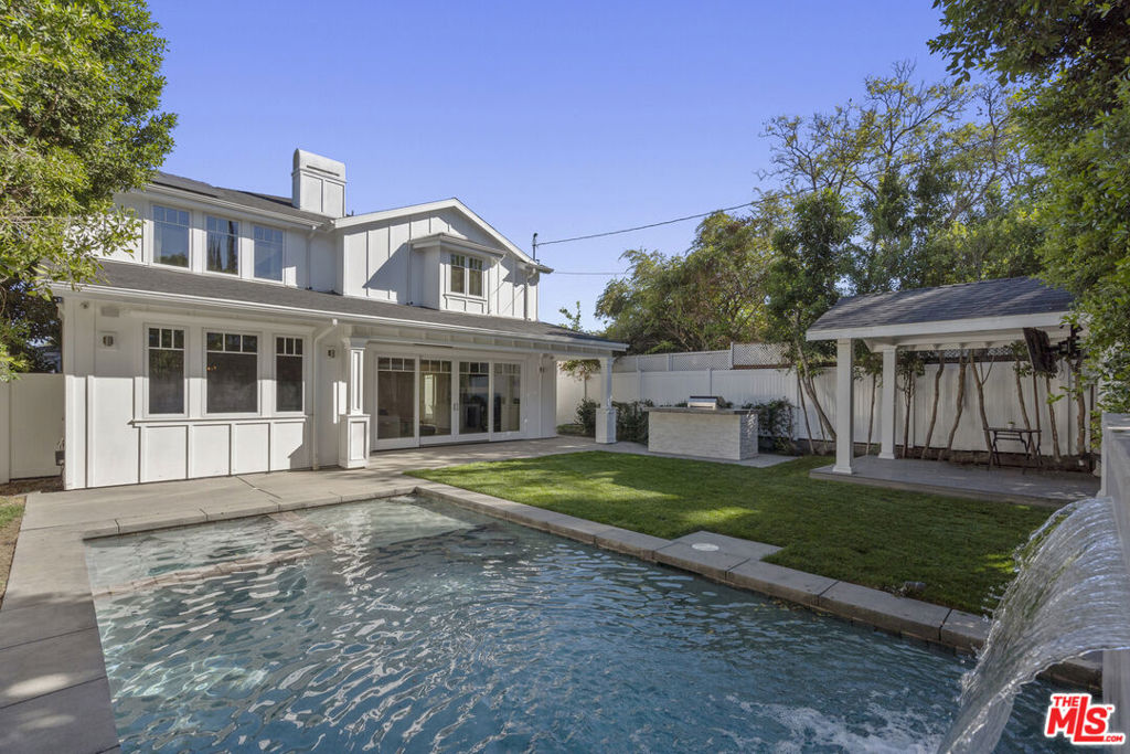Light & bright modernized Traditional w/ high ceilings & an ideal open floor plan in the highly coveted neighborhood of Tujunga Village. Fully equipped to function as a smart home w/ LED lighting & security cameras. Great flow throughout, the living room & dining area spills into the expansive family room & kitchen w/ large center island, wolf range, stainless steel appliances, breakfast area, butlers pantry & walk-in pantry. Downstairs home office + temperature controlled wine storage. 2-car attached garage outfitted w/ laminate wood flooring & mirrored walls for a proper home gym + mud room. 4 large en-suite bedrooms up + laundry room, inc. the spacious primary suite w/ fireplace & spa-like bath w/ pedestal tub, oversized shower & double walk-in closets. The living room & kitchen open to the backyard onto a covered & heated patio w/ built-in bbq, large grassy lawn, pool & spa + cabana w/ T.V. & lounge. Great proximity to all of the shops & restaurants in prime Studio City location.