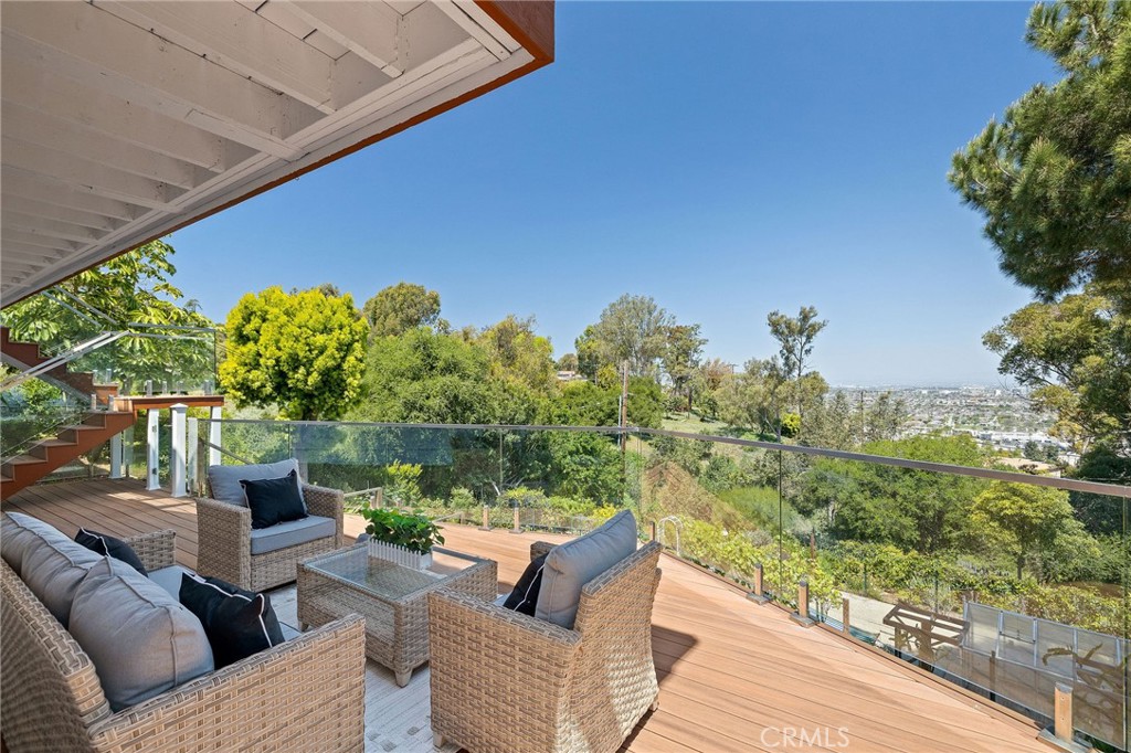 Don’t miss this rare opportunity to own a turnkey home in one of Palos Verdes’ most coveted neighborhoods! Escape to your serene sanctuary and secret garden, boasting breathtaking views of open space and twinkling city lights. Nestled in one of the safest cities, this Palos Verdes Estates home offers a tranquil hillside retreat, blending seclusion with convenient amenities access, in addition to one of the top school districts in CA. Turnkey with dual master suites on both floors and set on an expansive 14,789 sq ft lot, this 4-bedroom, 4-bath home offers the perfect blend of coastal living, comfort, and privacy. Welcome to a home that invites you to slow down, breathe deeply, and enjoy the best of South Bay living. Step inside to find soaring vaulted ceilings, a spacious open-concept living room, formal dining area, and a chef’s kitchen with stainless steel Viking range and hood, all boasting stunning canyon and city light views. The main level also features an oversized en-suite guest bedroom, a separate laundry room, and a half bath. The attached 2-car garage includes an extended driveway for ample parking—perfect for families and entertainers alike. Downstairs, you’ll find three additional bedrooms and two bathrooms, including a luxurious primary suite with a walk-in closet, private fireplace, and spa-like en-suite bathroom featuring dual sinks, a soaking tub, and a separate shower. Recent upgrades include new kitchen backsplash, fresh interior and exterior paint, finished bonus room for storage or home gym, and two expansive TREX decks ideal for entertaining or relaxing outdoors. The beautifully landscaped backyard is an entertainer’s dream—complete with mature fruit trees, drought-tolerant landscaping, a greenhouse, and direct access to scenic hiking and nature trails. Located near award-winning Palos Verdes Unified schools, walking trails, and just minutes from the beach, golf courses, high-end shopping, and fine dining, this home truly offers the best of the California coastal lifestyle.