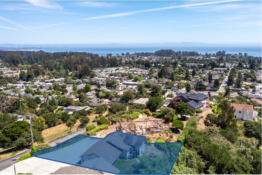 Calling all contractors! Enjoy big views in a small footprint! This charming ~825 sq ft home offers light-filled living spaces, an efficient kitchen, 1 bedroom with a walkin closet, and 1 full-size bathroom. Large windows showcase panoramic ocean views of Monterey Bay and the Santa Cruz Mountains. Low-maintenance and close to beaches, shops, and trails, this is an ideal full-time home, weekend retreat, or investment property with some of the best views in Santa Cruz County.    Add a garage door, turn the ~270 sq ft art studio/workshop into a living space, build a wrap-around deck off of the back extrance to capture the epic views.  The possibilities are endless!