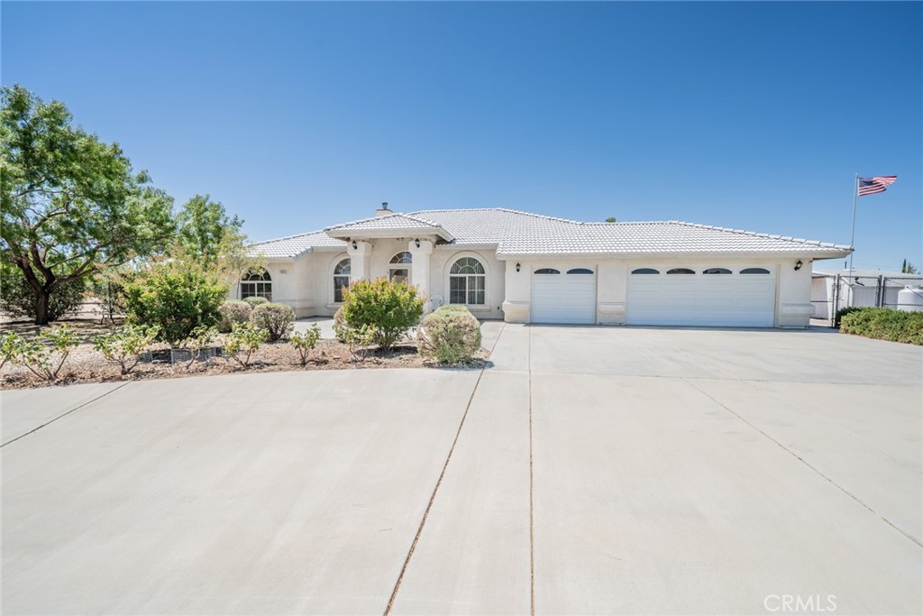 This home has inviting curb appeal, mature trees, and meticulously landscaped grounds, located not far from a paved road. Step inside and experience this thoughtfully custom designed home, highlighted by soaring high ceilings and abundant natural light. The spacious family room sets the tone for relaxation or entertaining, featuring a charming wood burning stove perfect for chilly evenings. The formal dining room invites you to enjoy meals with family and friends. The heart of the home is the open kitchen, boasting generous storage, expansive counter space, and a convenient breakfast bar and nook—ideal for casual dining or entertaining. The adjacent laundry room ensures everyday tasks are handled with ease. Unwind in the comfortable bonus room, ready to serve as a home office, game room, or hobby space tailored to your needs. This home’s split floor plan offers privacy, with the master bedroom offering a personal retreat at one end. The master bath features a walk-in shower and separate soaking tub for pampering, while the additional two bedrooms and second bath provide flexibility for family, guests, or workspace. Air conditioning and vented evaporative cooler ensures year-round comfort. Outside is a 30 x 40 Building with 2-16 foot drive through doors, 8 foot door and man door, 30amp power and lighting. Enjoy morning coffee or evening gatherings in the expansive fenced yard, surrounded by mature landscaping that provides both beauty and shade. The large circular driveway, three-car garage, dedicated RV parking, and handy sheds deliver all the space and storage you could wish for. Make this yours today!