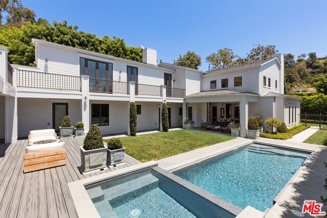 Stunning designer-done modern East Coast Traditional in the coveted Bird Streets with quintessential in/outdoor LA living. Soaring ceilings, magnificent chandeliers and beautiful staircase creates a grand entrance to impress. Open floor plan flows between living room (with a fireplace), family room, gourmet eat-in kitchen and outdoor living room with disappearing pocket doors. Master suite with dual closets, fireplace, patio, exquisite bath. Completely gated pool area surrounded by lush flat grounds. Movie theater, wine gallery and incredible guest house with sauna and separate entrance. Three-car garage plus plenty of off-street parking makes this an entertainer's dream. Marble and quartz counters throughout, Lutron smart-home system and detailed wood paneling.