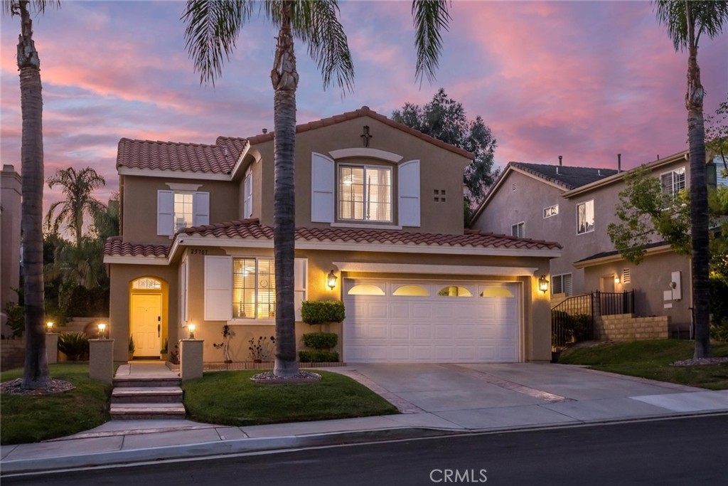 Welcome to this stunning Executive Home, ideally located in the highly sought-after upper Stevenson Ranch neighborhood on a picturesque street that radiates pride of ownership. From the moment you arrive, you will immediately notice the picture-perfect curb appeal adorned with meticulously manicured landscaping and featuring beautiful mature palms. Spanning nearly 3,000 square feet, this home boasts four bedrooms (one down,) den/bonus room, three baths, formal living and dining areas, family room, loft, spacious laundry room with sink, and upgrades throughout. As you walk in you will notice the soaring cathedral ceilings, beautiful LVP wide plank flooring in Canyon Oak, inviting paint selections, newer carpeting upstairs, and several windows flooding the space with natural light. The home's chef will love the updated kitchen including a wealth of cabinetry, stainless appliances, stylish quartz counters with seamless backsplash, spacious center island, and a convenient breakfast nook. The dining room is highlighted by a gorgeous chandelier, tray ceiling and views of the backyard. Entertain with ease in the large family room with a cozy fireplace and easy access to your entertainer's backyard. Upstairs, you will find the luxurious primary suite that is generous in size, includes a large walk in closet and enjoys views of the surrounding landscape. Enjoy the private ensuite bath, complete with dual sinks, an oversized soaking tub, and a separate walk in shower. The secondary bedrooms are generously sized and offer ample closet space. The hall bath features dual sinks and a private shower room. The loft is perfect for a home office or additional relaxation area. Step outside and discover an entertainer's space featuring a large covered patio, BBQ island and a huge grassy area for play. Don't miss the additional upgrades of a newer water heater, outdoor shed and newer exterior paint! Minutes away from shopping, Richard Rioux Park, award-winning schools, and effortless freeway access! This home embraces the essence of Southern California living at its best!