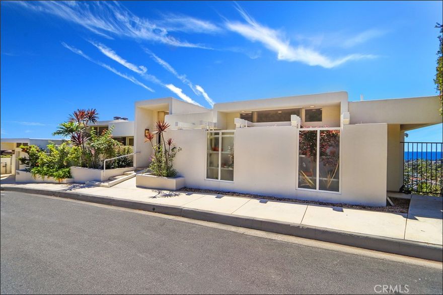 UNRIVALED PANORAMIC OCEAN VIEWS FROM EVERY ANGLE set the stage for this rare Laguna Beach escape perched high above the village. Floor-to-ceiling glass captures endless blue horizons and glowing sunsets, filling the home with natural light and an easy coastal vibe. Inside, soaring ceilings and stone floors frame an open living area anchored by a clean-lined fireplace. The newly remodeled kitchen blends quartz counters, custom gray cabinetry, and stainless appliances with a picture window that makes the ocean feel within reach. Multiple decks and terraces create seamless indoor/outdoor flow, while a private pool invites afternoon swims and evening gatherings. Generous bedrooms each open to view balconies and offer exceptional built-in storage. Spa-style baths and thoughtful details throughout keep the design timeless and practical. Huge 3rd bedroom suite / large second master suite at pool level with private entrance or access via elevator from the main floor. There is also a large storage room at pool level. Just minutes from beaches, galleries, restaurants and village shops, this home delivers privacy, style, and those jaw-dropping Laguna views in every direction.