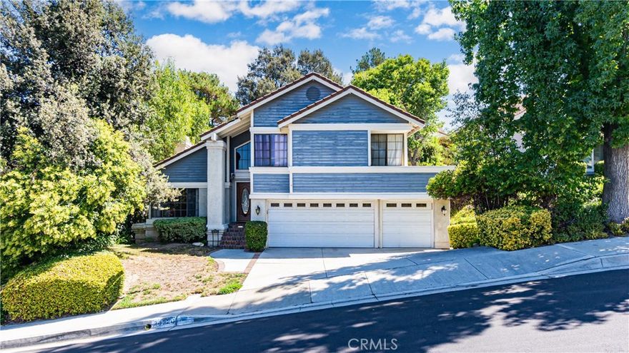 Welcome to 24220 Mentry Dr, Newhall, nestled in the prestigious Hidden Valley area of Santa Clarita. This expansive 5-bedroom, 3-bathroom home offers approximately 2,930 sq ft of comfortable living space. Step inside to find a bright, airy living room and a formal dining area that set the stage for elegant entertaining. The heart of the home is the open kitchen, which connects to a cozy breakfast nook and a welcoming family room complete with a fireplace — perfect for gatherings on cool evenings. On the main level, a convenient bedroom and full bath offer flexibility for guests or a home office. Upstairs, the spacious primary suite provides a private retreat with an en-suite bath and ample closet space. Three additional bedrooms and another full bath complete the upper floor.  Outside, enjoy the serene backyard with a spa/Jacuzzi under a charming gazebo, perfect for unwinding or hosting outdoor gatherings. The 3-car garage, inside laundry, and ample driveway parking, including space for an RV or boat, add to the home’s convenience. Residents enjoy community amenities like a pool, spa, tennis, and pickleball courts, and easy access to local trails. With top-rated schools, shopping, dining, and freeway access just minutes away, this Hidden Valley gem offers the perfect blend of comfort, location, and lifestyle. Don’t miss out on making it your own!