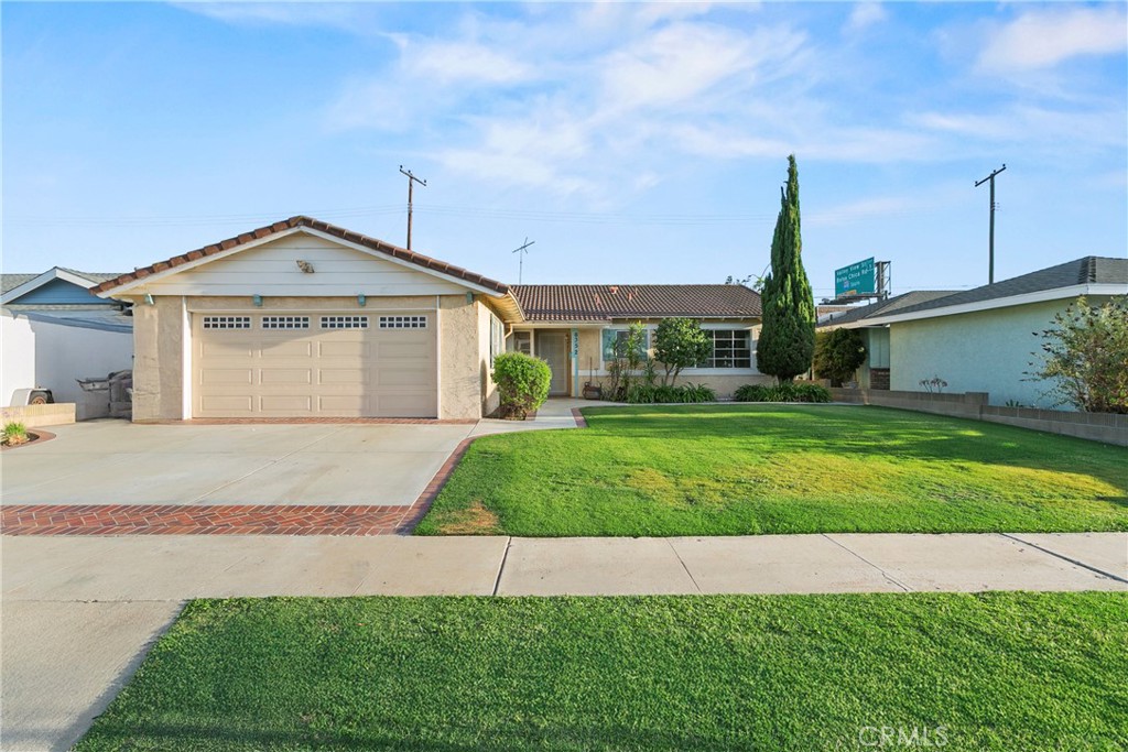 Fantastic purchase opportunity on this 4 br 2 ba single story home located in the popular West Garden Grove area. Great curb appeal with lush green lawn and brick ribbon hardscape, tile roof, spacious living room with fireplace, laminate floors & sliding glass doors leading to a covered patio and backyard, kitchen with ample cabinets, tile countertops, fully vented cooktop, pantry, and adjacent dining room, neutral tile floors in entry, kitchen and dining room, forced air heating and central air conditioning, nice size bedrooms, spacious back bedroom with 2 sets of closet doors and a door leading to the backyard,1 bedroom can be office/ den, hallway full bath with tub and tile floors, ensuite bathroom with shower and tile floors, 2 car direct access garage with automatic overhead door opener and lots of built in storage cabinets, front landscape on sprinklers, large covered patio area and low maintenance backyard for limitless possibilities. Don't miss out!