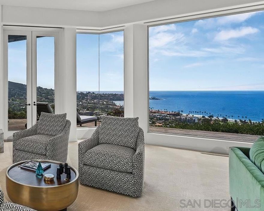 Dramatic, sweeping sunset and open sea views from the La Jolla hills south of La Jolla Cove to the La Jolla Beach & Tennis Club--and the whitewater of La Jolla Shores Beach and the North Shore-- are perfectly framed by renowned architectural designer, Ken Ronchetti, whose aesthetic sense of luxurious nonchalance invites maximum enjoyment of this spectacular panorama in a relaxed-while-opulent manner. Constructed with exceptional steel beaming and dozens of caissons, the unique architecture welcomes guests into a gate-guarded, secluded center courtyard with fireplace, water feature and two guest casitas leading to living areas including walls of glass to the views, recently renovated kitchen and baths, and a dazzling master suite embracing views to the marine environment outdoors. This important Prestwick Estates residence offers both exceptional stature and value for the most discerning clientele.  This magnificent one-level home offers a great room floor plan with living room, kitchen, dining and bar area combined for easy entertaining, a spectacular sea view master with fireplace and sauna opening to spa, and two completely private guest suites across the center courtyard with fireplace.