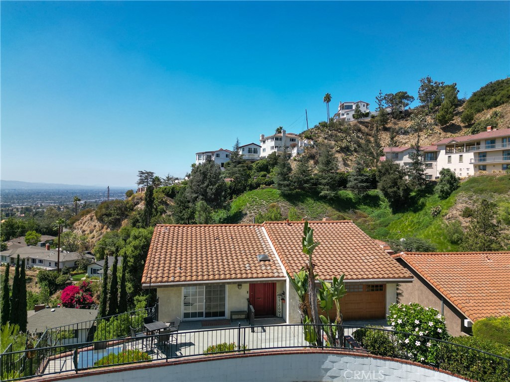 Welcome to this beautiful, multi level contemporary view home nestled in a desirable Burbank Hills with breathtaking, panoramic views and stunning light throughout the day. Functional floor plan provides spacious living spaces, privacy and tranquility. Sunbathed open floor plan welcomes you to an elegant living room with polished marble floors and fireplace and formal dining room. Expansive balcony that runs along the entire length of the living room and formal dining room featuring captivating hillside views all the way to DTLA, San Fernando Valley and Burbank is a perfect place to relax and enjoy the sunset. Exceptional cherry wood chefs kitchen with granite countertops and custom cabinetry is conveniently located between the dining room and family room complete with a breakfast area. Also upstairs is a guest powder room and family room with direct access to the outdoor patio. Downstairs is truly its own world, including large sunny primary suite with walk-in closet and view balconies plus additional bedrooms, bathroom, and laundry room. The separate guest quarters with separate bedroom, bath, office and large living area are located on a ground level and can be accessed from the private backyard patio. Ideal for guests and the extended family. 2-car attached garage. Enjoy convenient access to top-rated schools, shopping, dining, entertainment, and all that Burbank and Glendale have to offer. This home has so much to offer and is an absolute must see!