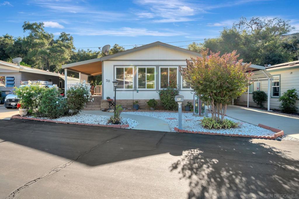 Single-story 2BR/2BA home in the extremely desirable, 55+ resort living community of the ‘Champagne Village’ in Escondido! Golf course, Pools & Spa’s, bocce & sports courts, dog park, on-site RV storage & parking, guard gated entry w/ concierge entry are just a few of the amenities available to homeowners in this fantastic neighborhood! The home features an open floor-plan w/ a huge living room w/ mountain VIEWS & vaulted ceiling throughout the floor plan, giving it a spacious feel & allowing for tons of natural light throughout the whole house! Upgraded w/ Low-E windows & slider throughout, the kitchen has been remodeled & features 2 skylights in the ceiling, fans in every room, a covered front porch & back deck overlooking the spacious, private backyard area just perfect for outdoor dining & entertaining or enjoying time alone. Hardscape upgrades include stamped concrete & secluded seating area w/ fire pit for those relaxing evenings. Other features include Central AC for cooling the interior, full-size indoor laundry for convenience & walk-in closet in the primary BR, covered carport w/ plenty of room for parking, storage & more. All appliances convey. This home affords all the luxuries of the active 55+ lifestyle community of the Champagne Village in North Escondido. It’s a close walk to the Village Hall for the neighborhood gatherings & events, the private golf course & resort-style living amenities & the community is guard-gated w/ no access from outside guests without the owners permission. Monthly HOA fee includes trash & sewer w/ boat &/ or RV parking included inside the park. Home is move-in ready & the best part… there is NO space rent in the Champagne Village as you'll OWN the land your home sits on. Home has a 433-C 'Cert' on-file & recorded with SD County. Come see for yourself!