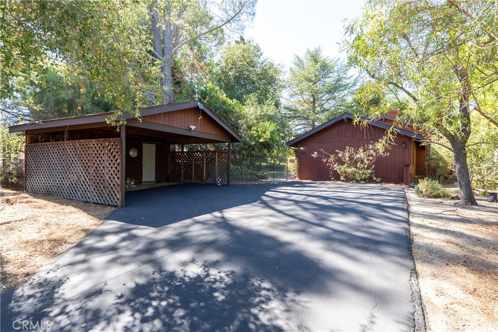 Tucked away at the end of a serene road, this charming 5 bedroom, 3 bathroom home offers the perfect blend of privacy, space and country lifestyle on ~2.82 beautifully maintained acres. Step inside to a warm and welcoming layout featuring a spacious living room with vaulted ceilings and a cozy pellet stove—perfect for gathering on cool evenings. The kitchen is efficiently designed with plenty of cabinetry and easy access to the heart of the home. Four generously sized guest bedrooms provide ample space for family, guests or home offices, while the primary suite offers two closets and an ensuite bathroom for your own private retreat. Out back, relax under a large trellis covered in mature grapevines or soak in the spa surrounded by shady, established trees that offer both beauty and seclusion. The property is thoughtfully equipped for those who love to work, grow or play outdoors, with a powered workshop, RV pad, dog run, chicken coop and a fenced garden ready for your seasonal vegetables. A mature fruit orchard features a delicious mix of apple, peach, plum, apricot, pear, almond and persimmon trees, giving you a true farm-to-table lifestyle. And for animal lovers or 4H families, the large pole barn and fenced pasture provide the perfect setup for horses or livestock. With room to grow, space to roam and endless potential, this home offers a rare opportunity to enjoy peaceful country living just minutes from town. Homes in this desirable area don’t last long—schedule your private showing today before it’s gone! Please review the Virtual Tour for additional information.