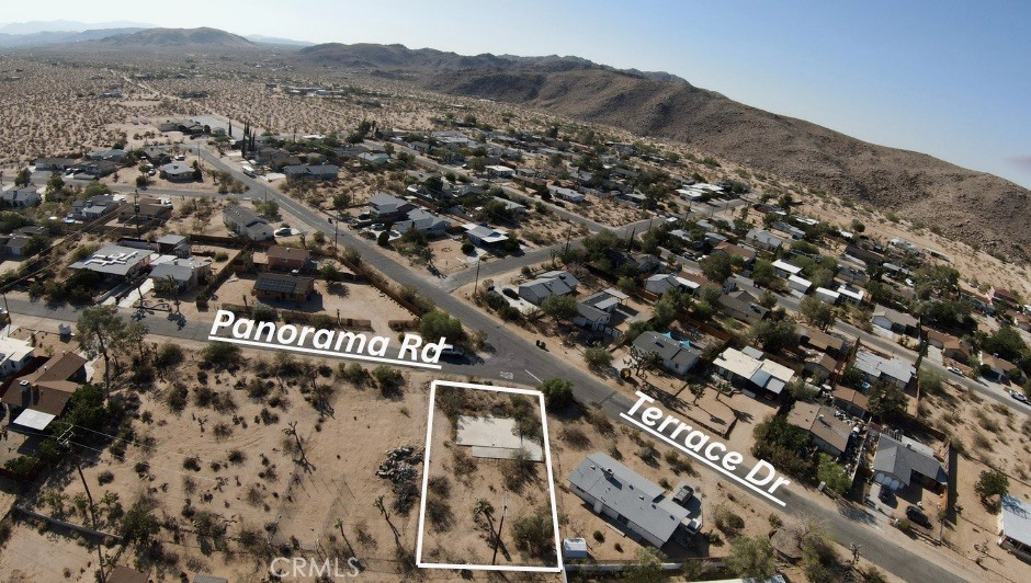 Prime lot with WATER SERVICE ALREADY ACTIVE AND A POWER POLE at the rear—saving you time, money, and stress. Reconnecting the water meter runs just under $500, per Joshua Basin Water District, giving you a rare utility-ready canvas in one of the desert’s most creative and sought-after communities. Nestled in the desirable Old Town West neighborhood just north of Hwy 62, you're less than three minutes from downtown Joshua Tree and its beloved hotspots like the Joshua Tree Saloon, Sky High Pie, Crossroads Café, and Joshua Tree Coffee Company. In under 10 minutes, you can be inside Joshua Tree National Park—hiking, climbing, or simply soaking in the magic of the Mojave. Whether you're dreaming of a custom build, a desert getaway, or a future investment, this lot offers the perfect launchpad to turn vision into reality. Own your piece of the High Desert and bring your Joshua Tree story to life. Build your dream in the heart of Joshua Tree today!