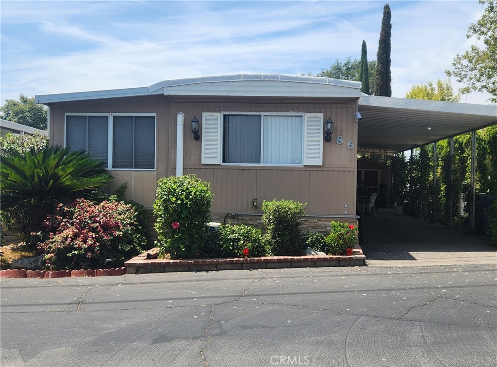 Charming Mobile Home with Unique Yard and Exceptional Amenities in a Family-Friendly Community! Welcome to this well-maintained 2-bedroom, 2-bathroom mobile home, featuring a versatile addition (approximately 26.5’ x 7.5’) that can be used as a third bedroom, utility room, office, or flexible living space. Truly One-of-a-Kind Yard: Enjoy a private outdoor oasis with mature fruit trees including lemon, orange, grapefruit, pomegranate, and fig. There's also a dedicated area perfect for growing your own vegetables—ideal for garden lovers! Interior Highlights: New roof installed in early 2023, A/C and heating throughout, with additional cooling systems in both bedrooms for personalized comfort, Stackable washer and dryer, Refrigerator included, Spacious storage shed. Exterior Features: Automatic sprinklers in both front and back yards, Enhanced security with exterior lighting and three Ring security cameras. Community & Lifestyle: Located in a safe, peaceful, and family-oriented mobile home park, this property offers a welcoming environment ideal for all ages. The community features include: Two swimming pools, Jacuzzi, Dry sauna, Clubhouse and recreation room, RV parking available through the park. This home offers the perfect blend of comfort, security, and outdoor charm—all within a warm, community-focused setting. A must-see opportunity!