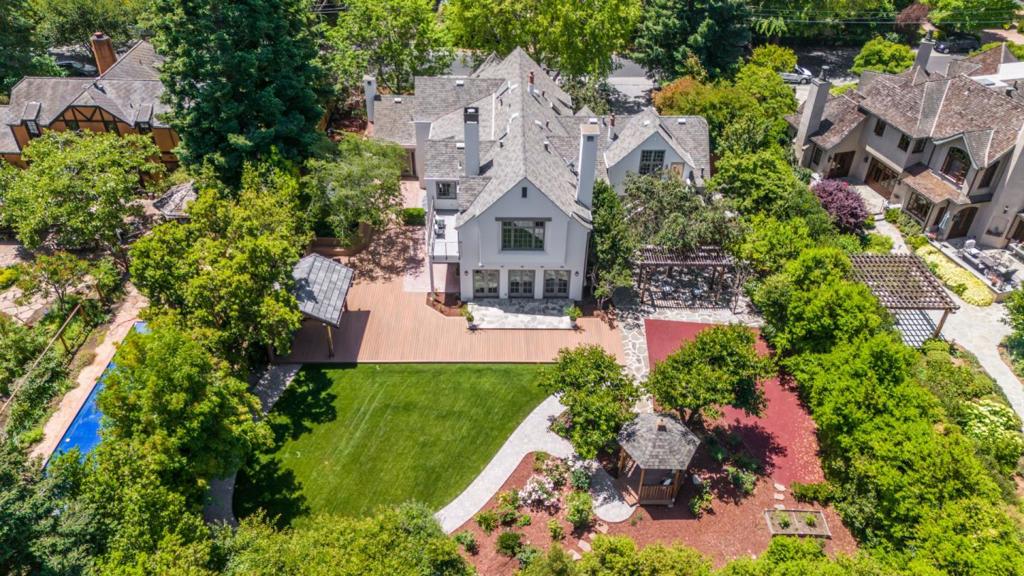 Nestled on a highly sought-after street in Menlo Park, this elegant 4-bedroom, 3.5-bathroom home spans approx. 5,300 sqft ( Main home: ~4,885 SF + detached studio: ~415 SF) on a 20,628 sqft lot. From the tree-lined street to the meticulously designed interior, this home exudes charm and attention to detail. The gourmet kitchen features Miele and Bosch appliances, while radiant floor heating adds comfort to all bathrooms. The seamless indoor-outdoor living experience extends to the outdoor kitchen with a Wolf grill, a spacious deck for gatherings, and a rubber playground for kids. And a dedicated multipurpose room above the garage offers flexibility as an office, theater, or gym. The home is conveniently located within a mile of downtown shopping and dining, and offers access to top-rated public and private schools, close to Menlo School, Sacred Heart School, and the Menlo Circus Club. Additionally, Menlo Park's proximity to major tech companies in Silicon Valley . This luxurious home provides a peaceful retreat within easy reach of the finest the Bay Area has to offer.