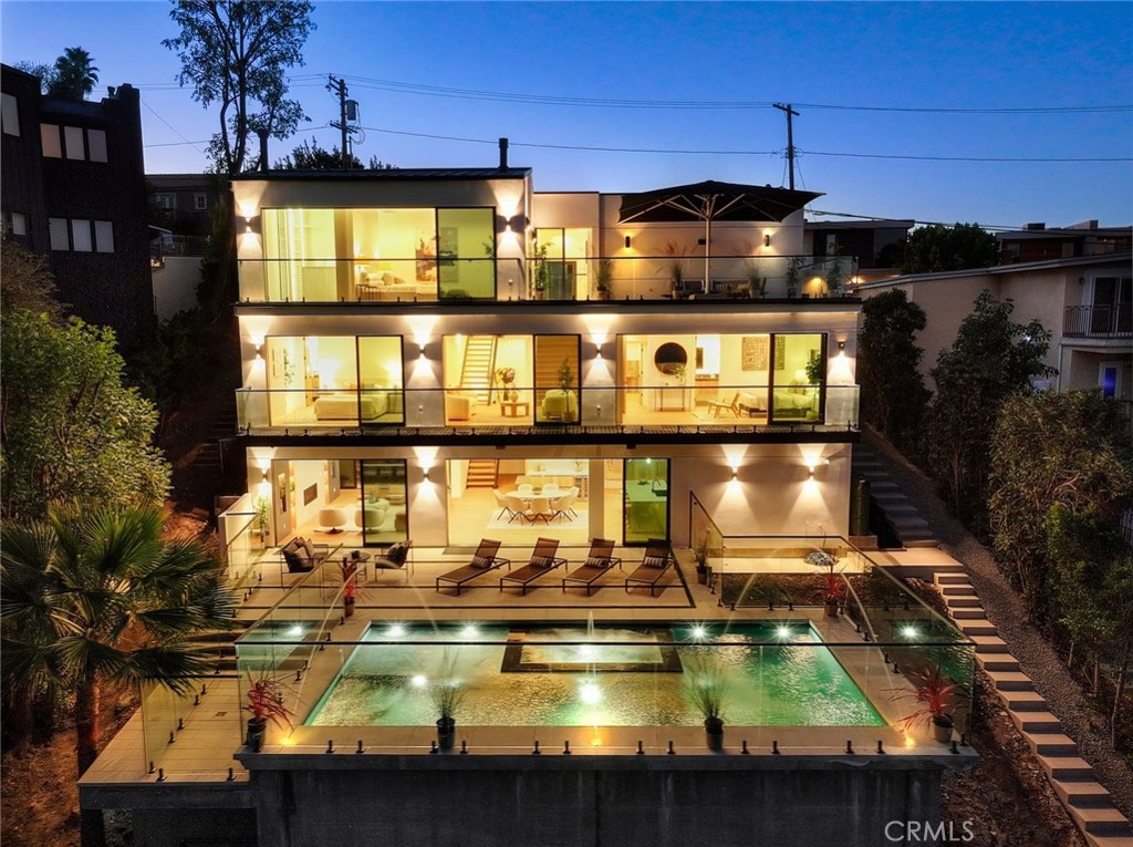 BRAND NEW MODERN LUXURY HOME IN ENCINO HILLS!
Experience elevated living in this newly built modern masterpiece nestled in the Encino Hills, south of the Boulevard. Spanning approximately 4,282 sq ft, this stunning residence features 5 bedrooms and 5 full bathrooms, blending contemporary design, comfort, and functionality.
An open floor plan with expansive glass doors fills the home with natural light and showcases breathtaking views of the surrounding hills and woods. The main kitchen, with its sleek island and high-end finishes, serves as the heart of the home, complemented by a fully equipped Butler’s kitchen for effortless entertaining.
The living areas flow seamlessly to the outdoor patio and cantilever pool overlooking the tranquil forest, creating the ultimate California indoor/outdoor lifestyle. Enjoy morning coffee or sunset gatherings on the rooftop deck with panoramic views.
Additional highlights include a 2-car garage, solar panels, custom cabinetry, designer finishes, and Dekton stone countertops—crafted with precision.
Offering peace, privacy, and sophistication, this home embodies the modern Encino lifestyle—where architectural elegance meets relaxed luxury, just minutes from fine dining, shopping, and the best of the Boulevard.