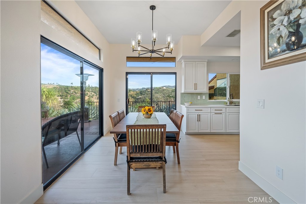 A hidden gem in the heart of Temecula’s countryside, offering privacy and tranquility. Expansive 3,354 sq ft vintage-style home with timeless architectural details and warm finishes. Spacious living and dining areas, perfect for Family/ Friends gatherings and entertaining guests. Large kitchen with classic cabinetry, ample counter space, and natural light 4 generously sized bedrooms, including a luxurious primary suite. Three well-appointed bathrooms designed for comfort and convenience. Plenty of space for gardening, outdoor recreation, or potential future development. Peaceful setting yet just a short drive to wineries, shopping, dining, and top schools. This property combines vintage charm with modern space, making it a perfect retreat or family estate. Experience the serenity and beauty that only a property of this scale can offer. Over 9 acres of land surrounded by picturesque views of rolling hills and nature, planted with over 600 Haas avocados trees. Don’t miss the opportunity to make this magical oasis your own!