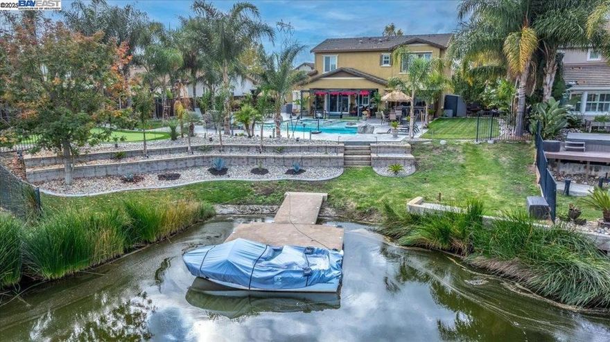 SUMMERLAKE COMMUNITY - ONE OF A KIND TROPICAL PARADISE! THIS STUNNING HOME OFFERS: PRIVATE POOL & SPA W/GROTTO STYLE WATERFALL - PAID SOLAR - TANDEM 3 CAR GARAGE W/TESLA CHARGER INSTALLED - 4 BEDS / 3 FULL BATHS + BONUS LOFT -(ONE BED/BATH ON MAIN LEVEL) - 14,446 SQ FT LOT LOCATED ON THE LAKE W/BOAT DOCK - Open concept living w/modern touches throughout - Spacious great room / dining area - Chef's kitchen w/granite counters, Center Island w/eat at bar & SS appliances - Upper open loft/bonus area - Primary Suite w/Lake view, dual vanity sink, stall shower & walk in closet - Upper laundry room - BACKYARD PARADISE with your own private pool/spa, Custom outdoor BBQ Island & bar w/premium Lion appliances, 50" TV & surround sound - Added waterfall to pool w/separate pump & lighting feature - Large putting green - Tropical landscaping w/palm trees and cactus throughout - Natural gas center fire pit - Fully landscaped front & back w/low voltage lighting - Extended driveway with concrete side yard - Stamped concrete curbing both front & back - Cobble stone ground cover at front & back yards - SUMMER LAKE COMMUNITY OFFERS: Olympic-sized pool, tennis and basketball courts, scenic walking trails, and several parks, activities & close to restaurants & Delta for fishing, boating and more...