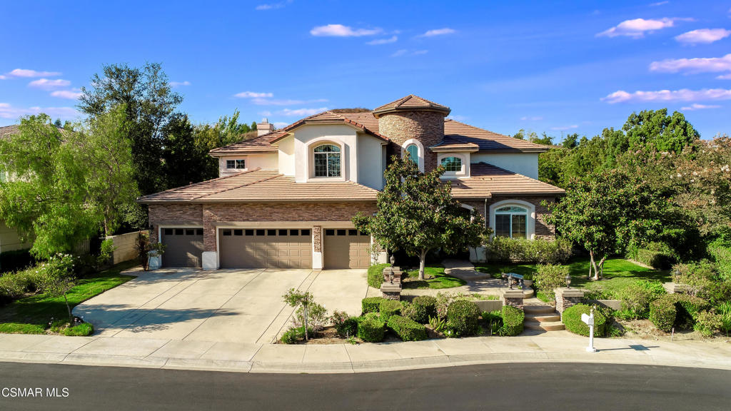 Welcome to your dream home nestled in the prestigious gated community of the Moorpark Country Club Estates--a perfect fusion of timeless elegance, resort-style amenities, and luxury. This stunning 5-bedroom, 6-bathroom estate offers a lifestyle of comfort, sophistication, and unforgettable entertaining, all set against the serene backdrop of rolling hills and meticulously landscaped grounds. From the moment you step into the grand foyer, you'll be captivated by soaring cathedral ceilings, marble floors, and a sweeping staircase that sets the tone for the rest of the home. The formal living and dining rooms are beautifully appointed with breathtaking views of the lush backyard--ideal for both intimate dinners and festive gatherings. The heart of the home is the chef's kitchen, featuring top-of-the-line appliances including a Viking range and hood, Electrolux double ovens, Bosch dishwasher, an oversized island, custom Italian tile backsplash, a walk-in pantry, and a cozy breakfast nook. Designed for functionality and style, this kitchen is built for both culinary creativity and everyday convenience. Enjoy seamless flow into the spacious family room, complete with built-in entertainment cabinetry, bar area, and a custom wood-burning fireplace--perfect for relaxed evenings or hosting friends. A conveniently located downstairs bedroom with a private en-suite bath offers an ideal space for guests or multigenerational living, along with a separate home office. Upstairs, retreat to the luxurious primary suite featuring mountain views, a private sitting area, and an expansive spa-inspired bathroom with dual vanities, jetted soaking tub, oversized walk-in shower, and a generous walk-in closet. Three additional bedrooms, each with private en-suite bathrooms, offer exceptional comfort and privacy. An additional loft space upstairs provides the perfect flexible area--ideal as a media room, play space, secondary office, or cozy retreat. Step outside into your private resort-style oasis, designed for pure enjoyment. A sparkling pool and spa with a custom rock waterfall, built-in BBQ bar, lush landscaping, mature fruit trees, a tranquil herb garden and multiple lounging areas complete this entertainer's paradise. Additional features include a 4-car garage, dual-zone climate control, and access to community tennis courts, pickleball, a playground, and scenic walking trails. Just minutes from Moorpark's top-ranked 27-hole country club golf course, this estate is more than a home--it's a lifestyle. Don't miss your chance to own one of Moorpark's most extraordinary properties. Schedule your private showing today and experience luxury living at its finest.