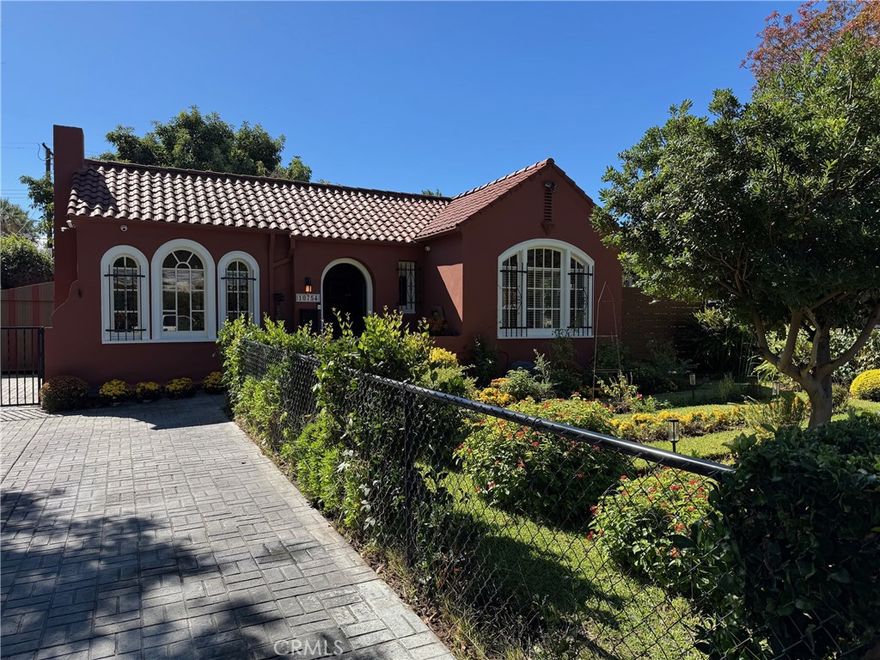 This 1925 Spanish-style artist retreat home blends original character with modern updates. The living room features an original California tile gas fireplace, vintage plaster walls, and original windows. The dining room connects to a small sunroom with casement windows. The kitchen is equipped with under-counter lighting, stove is dual fuel gas on top with electric oven, stainless steel appliances, butcher block and granite counters, and a built-in china cabinet in the breakfast nook.

The home offers two bedrooms and two bathrooms with Cove ceilings in the living room and dining room. The guest bedroom has a vintage window, French door, and hardwood floors, while the primary bedroom provides backyard access and hardwood floors. The main bathroom has fresh paint and a cast-iron tub. Both bedrooms have ceiling fans, and the primary bedroom has 9-foot ceilings.

With fresh interior and exterior paint, recessed lighting, and a new flat roof, this home also includes modern updates like a 2-ton AC unit with heat pump, 200-amp electrical service, newer plumbing, and a tankless water heater. A detached studio/office is attached to the single-car garage, which has extra storage space. The backyard features a inviting deck and brick terrace.

This home is full of original charm and thoughtful updates, located in a fantastic area.