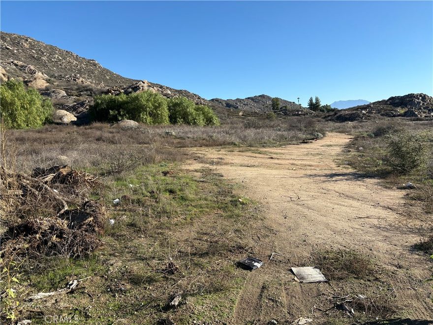 Discover nearly 37 acres of prime land along Highway 74 in Hemet—APN 458-030-001—a rare opportunity in a rapidly developing corridor with direct frontage on a major route and just a short drive to the I-215. This expansive parcel offers a mix of usable ground and elevated terrain with beautiful mountain and valley views, including a flat upper area ideal for a future homesite, ranch set-up, or other allowable uses. Located next to an established mobile home park and various commercial properties, this site offers excellent visibility and long-term potential. According to county zoning, the property lies within the Rural Residential Zone (RR), which is intended for single-family residences on large lots with flexible provisions for the keeping of farm animals such as horses, ponies, mules, cows, goats, sheep, and swine under FFA or 4-H-supervised projects. Buyers are encouraged to verify all allowable uses, development options, and zoning details with Riverside County. A great investment opportunity in a growing area with unlimited possibilities. ****No soils reports, surveys, etc., have been done. Buyer and buyer's agent to verify all information with the city or county for allowable uses and requirements  and rely on their own investigations. **Buyer responsible for checking zoning, utilities, permits and exact property boundaries. ****