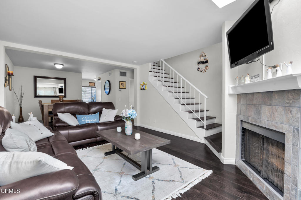 Welcome to Country Walk, a charming gated townhome community in the heart of Reseda. This 2-bedroom, 2-bath end-unit offers a thoughtful two-level layout with both bedrooms privately located upstairs and a spacious main level perfect for relaxing or entertaining. Step into a bright and inviting living area featuring a cozy fireplace and an open-concept flow into the dining space. The front patio provides a private outdoor retreat ideal for morning coffee, weekend BBQs, or evening unwinding. With 1,058 sq ft of comfortable living space, this home offers excellent functionality. The attached 2-car garage provides secure parking with direct access. The well-maintained community features a sparkling pool and spa, lush landscaping, and a peaceful neighborhood feel. Conveniently located near local shopping, dining, parks, and public transit, this home offers easy access to everything the San Fernando Valley has to offer. Don't miss this opportunity to own a private townhome in one of Reseda's most desirable gated communities.
