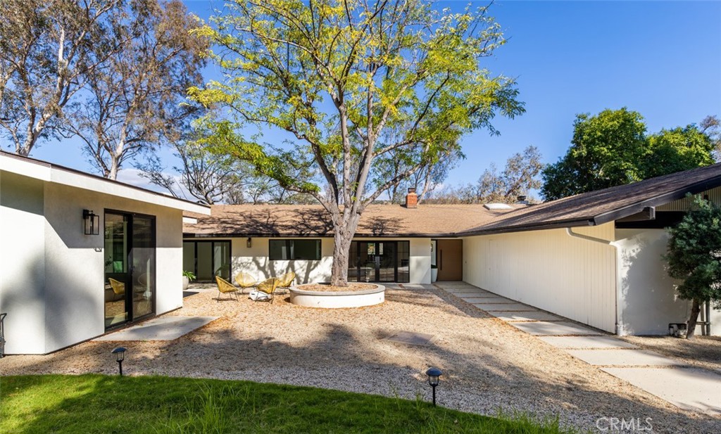 *Single-Level Luxury with Peters Canyon Views* Modern ADU* Office Retreat* Tucked in the prestigious Cowan Heights neighborhood of North Tustin, this stunning single-level estate combines modern design with serene retreat living. With breathtaking views of Peters Canyon, seamless indoor–outdoor flow, and a newly built ADU, the property is crafted for comfort, flexibility, and tranquility. The 2,112 sq. ft. main residence features 3 en-suite bedrooms, 3.5 bathrooms, and a private office with sweeping patio views—perfect for working or creating in peace. Vaulted ceilings, expansive windows, and sliding glass doors flood the home with natural light, while a fully remodeled kitchen anchors the open-concept design. High-end finishes throughout add an atmosphere of understated luxury. The newly constructed 803 sq. ft. ADU expands the possibilities, offering two bedrooms and two bathrooms, a generous living area, and vaulted ceilings—ideal for extended family, guests, or versatile living needs. Set on nearly 3/4 of an acre, the outdoor spaces are the heart of this home. A welcoming courtyard and canyon-view backyard invite dining, entertaining, and peaceful reflection, accompanied by the calming sounds of nature. Direct access to scenic hiking trails further enhances the retreat-like setting. Recent upgrades to electrical and plumbing provide peace of mind, ensuring the home is as reliable as it is beautiful. Rarely does a property offer this unique balance of modern luxury, natural beauty, and timeless serenity. More than a home—it’s a sanctuary.