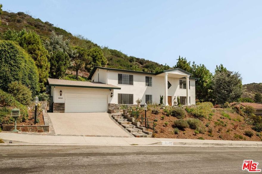 This traditional home, situated above the Getty Villa in the prestigious Pacific View Estates, offers breathtaking panoramic ocean views. Guests are welcomed by an expansive formal living room with a fireplace that flows out to the ocean views. A dining room, kitchen and an informal dining area open to the private backyard, featuring a large patio, lagoon-style pool/spa, fruit trees, and a built-in BBQ areaperfect for entertaining. The lower level is completed by a cozy family room, guest bedroom, laundry room with direct access to the two-car garage, and two well-appointed bathrooms. Upstairs, find three bedrooms including the primary suite, as well as an office. Ideally located just minutes from the Palisades Village, Malibu, Santa Monica, and just up the street from the beach, this home offers the ultimate coastal lifestyle.