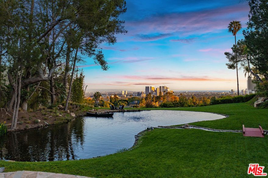 Tucked away on a quiet cul-de-sac in the heart of Beverly Hills, 1177 Loma Linda Drive presents a once-in-a-generation opportunity to own an extraordinary residence with incredible pedigree, privacy, and panoramic views. Designed and built by the S. Charles Lee, the iconic Los Angeles architect best known for his Art Deco and Moderne style motion picture theater designs - this over 8,800 sq.ft. single-story estate was created as Lee's personal family home, blending timeless design with serene sophistication. Set on an expansive and remarkably flat 1.3 acre lot, composed of two legal parcels, the estate offers sweeping views of Beverly Hills, Century City, and the distant Pacific Ocean. This secluded property is located just minutes from the world-class amenities of Beverly Hills, yet feels a world apart, offering unrivaled tranquility and prestige. The residence features six generously sized bedrooms and ten bathrooms, thoughtfully arranged to accommodate both intimate family living and large-scale entertaining. The grand formal living and dining rooms are complemented by a charming breakfast room, spacious gourmet kitchen, a large private home office, and a comfortable family room, perfect for casual gatherings. For ultimate indulgence and wellness, the home includes a Zen-inspired exercise and yoga room overlooking the koi pond, with canoe, waterfall and fountains. Step outside to discover the true magic of this unique property. At the center of the grounds lies a sparkling pool and one of the largest private ponds in Beverly Hills, home to graceful koi fish, bordered by a meandering stream that adds ultimate serenity to the property. The night-lit basketball and pickleball court, a spa nestled near the pond, a nature walk and the expansive grassy lawn offer countless opportunities for relaxation, recreation and entertainment beneath the stars. Additional features include a three-car garage, a large gracious motor court and two separate gates for service and catering providers access, all designed for effortless hosting and secure, discreet living. Whether envisioned as a private retreat with a park-like grounds filled with natural wonders or an enchanting venue for entertaining, 1177 Loma Linda is a one-of-a-kind legacy estate that captures the very essence of Beverly Hills luxury living.