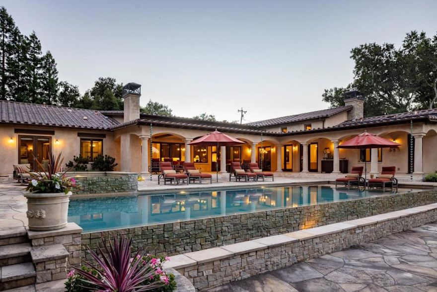 Located in a private, park-like setting, this exceptional single-level residence epitomizes the joy and ease of luxury living and indoor/outdoor entertaining. Multiple patios provide idyllic spaces for relaxation, reflection and al fresco dining. Come unwind in your pristine pool with cascading waterfall and spa complemented by two captivating fire features, or step inside and discover a thoughtfully designed open floor plan with great room, and large game/media room that provides an ideal option for spending leisure time with family and friends. French doors throughout seamlessly connect indoor and outdoor living spaces enhancing the sense of tranquility. The heart of the home is the chef's kitchen where culinary dreams, aspirations and creativity come to life. At the end of the day, retreat to the luxurious primary bedroom suite, a sanctuary of comfort with seating area and opulent bath with soaking tub. Additional features include separate office, wine storage room, attached oversized three-car garage, whole house A/C, beautiful rose gardens, verdant foliage, calming fountain and a plush lawn. With exceptional amenities, serene surroundings, and solar power for eco-conscious living, this property presents a rare opportunity to indulge in a lifestyle of unparalleled refinement.