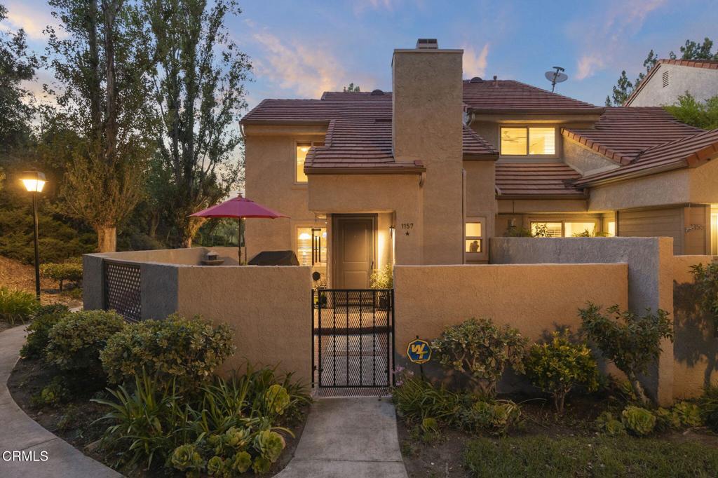 Welcome to your Hidden Canyon oasis. This beautifully updated 2-bedroom, 2.5-bath end-unit townhome offers the perfect blend of functionality and tranquility. Its prime location features a spectacular canyon view, creating a peaceful place to relax and unwind. The expansive, newly landscaped private patio with raised planters is perfect for entertaining and creates a seamless indoor-outdoor flow.Inside, the bright living room features soaring ceilings, a custom stone fireplace, warm wood floors, and a sliding glass door to the large brick patio. The kitchen is redesigned for maximum functionality with sleek Italian cabinets and drawers, glass-front uppers, stone counters and backsplash with custom inlaid tiles, and high-end stainless appliances including a Kohler sink. A large island provides seating and storage, and the adjacent dining room offers mountain views.A stylish main-floor powder room includes a custom vanity with stone countertop, stainless vessel sink, and faucet. Upstairs, the spacious second bedroom has a wall-to-wall mirrored closet, while the second full bath features a cast iron tub with glass enclosure, custom wood cabinetry, granite countertop, and wall-to-wall mirror.The primary suite boasts a spectacular custom walk-in closet with glass door cabinets, large drawers, granite countertop, and framed mirror, plus a wall-to-wall, floor-to-ceiling custom closet with adjustable cabinets and drawers. The en-suite bath includes a glass-enclosed shower, stained wood vanity with vessel sink, and LED backlit mirror.The attached two-car garage offers custom built-ins, workbench, epoxy flooring, a 2024 water heater, and insulated remote-operated garage door. Hidden Canyon provides three sparkling pools, relaxing spas, a playground, lush green spaces, and mountain views. Conveniently close to top-rated schools, scenic trails, the YMCA, and Westlake Village's best shopping and dining.