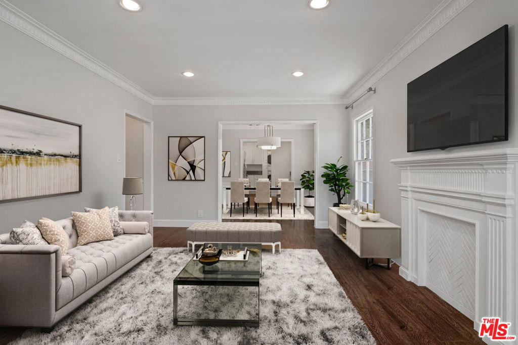 This sophisticated two-bedroom, two-bathroom apartment in a boutique three-unit building was redone with top-of-the-line style and designer finishes. The spacious living room is flooded with light through an expansive window and openly leads to the dining room with wainscoting and a chic light fixture. The sleek kitchen features bright, white cabinets and stainless-steel appliances. Upgrades include newer flooring, recessed lighting, fresh paint, modern remodeled kitchen, remodeled baths, and more. There is also central air and heat, in-unit laundry, and shared garage for extra storage. Welcome!