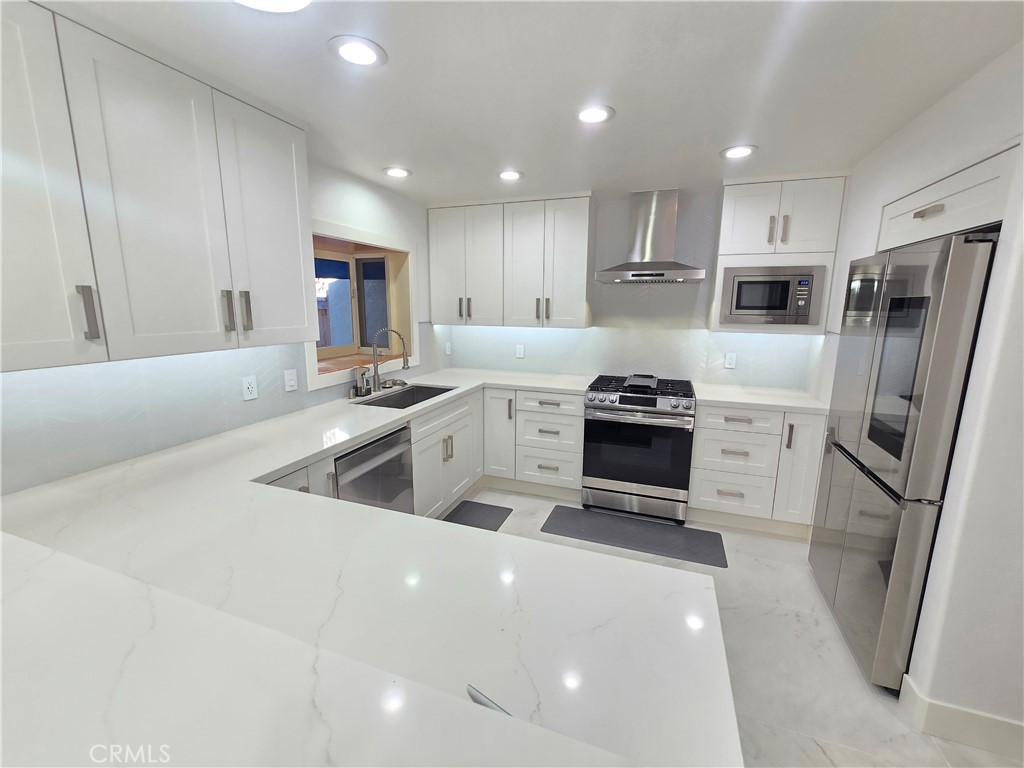 Beautiful high tech remodeled 3 bedroom, 2.5 bathroom, 2 garage, approximately 1600 sq ft. Fully redesigned kitchen with quartz counter tops, white Shaker style cabinets, designer brushed nickel pulls, two zone wine and beer cooler/frig, high end Samsung five-door digital-display refrigerator, top of the line ultra quiet dishwasher and high end 5 burner range/oven. all the light switches are wifi, all recessed lights throughout are wifil as well. Designer bathrooms, back light mirrors, custom floating quartz vanity, top of the line wall-hung toilet. Large living room with stone fireplace and views of large backyard. One bedroom is set up as a home office with vaulted ceilings and wifi recessed LED lighting. Master bedroom and 2nd bedroom are large with high ceilings. 2 Car garage houses top of the line washer and dryer. The back yard has tons of space, it is the largest in the community.