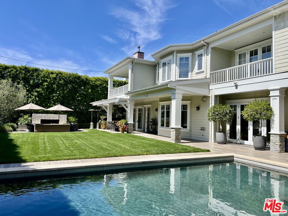 Set on one of Brentwood's most picturesque tree-lined streets, this thoughtfully designed 2008 traditional home offers timeless appeal, grand proportions, and ideal indoor-outdoor living. Beyond the grand two-story entry, a gracious open floor plan unfolds with perfectly proportioned rooms over 7,200 square feet. The home features 5 bedrooms and 6.5 baths. The main level includes formal living and dining rooms, an office with fireplace, and a guest suite, while the heart of the home is the open-concept chef's kitchen featuring top-of-the line Sub-Zero, Wolf and Miele appliances with a large center island, breakfast area with bay window, walk in pantry and expansive great room, all seamlessly connecting to the extraordinary backyard. Outside, a true private oasis awaits: a mature privacy hedge surrounds a flat grassy lawn, pool and spa, barbecue, large outdoor lounge area with fireplace, and a covered, heated dining patio - ideal for relaxing with the family or entertaining in style. Upstairs is a luxurious primary suite with fireplace, balcony, large spa-like bathroom and substantial walk-in closet. There are three additional generous ensuite bedrooms, as well as a family lounge with balcony, a gym, laundry room and linen closet. Additional highlights include a 3-car garage, high ceilings and thoughtful custom details throughout, and an unbeatable Brentwood location. Set on a wide 13,000+ sq ft lot the proportions of this home have to be seen to be believed. Attention to every detail. This is the one you simply don't want to miss.