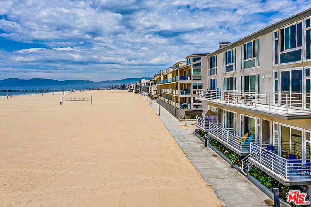 Spectacular and beautifully updated oceanfront condo perfectly situated on the Marina Peninsula with direct beach access! Enter into the grand living space of this open-concept, split-level-style home flooding with natural light and flaunting high ceilings, expansive windows, and sliding glass doors that frame sweeping ocean views and lead you out to the private balcony patio. The living area showcases a decorative fireplace and built-ins for extra seating and/or storage space. The kitchen comes complete with stainless steel appliances, stone countertops, ample cabinet and pantry space, and opens to a versatile dining flex-space overlooking the living area and picturesque views. The primary bedroom offers a large closet with sliding mirrored doors, separate storage closet, ceiling fan light fixture, window shutters, and direct access to the bathroom with a glass-enclosed tiled shower, ceiling heater light fixture, and vanity. Additional features and amenities include light wood flooring and recessed lighting throughout, two garage parking spaces, shared laundry room, lobby mailroom with controlled access, and a marvelous shared rooftop deck. This beachfront gem is mere steps from Washington Square restaurants and retail, and close to Abbot Kinney Blvd, the Marina's main channel; popular seaside recreation, dining, and shopping; Venice Canals, Boardwalk, and Pier; and so much more!