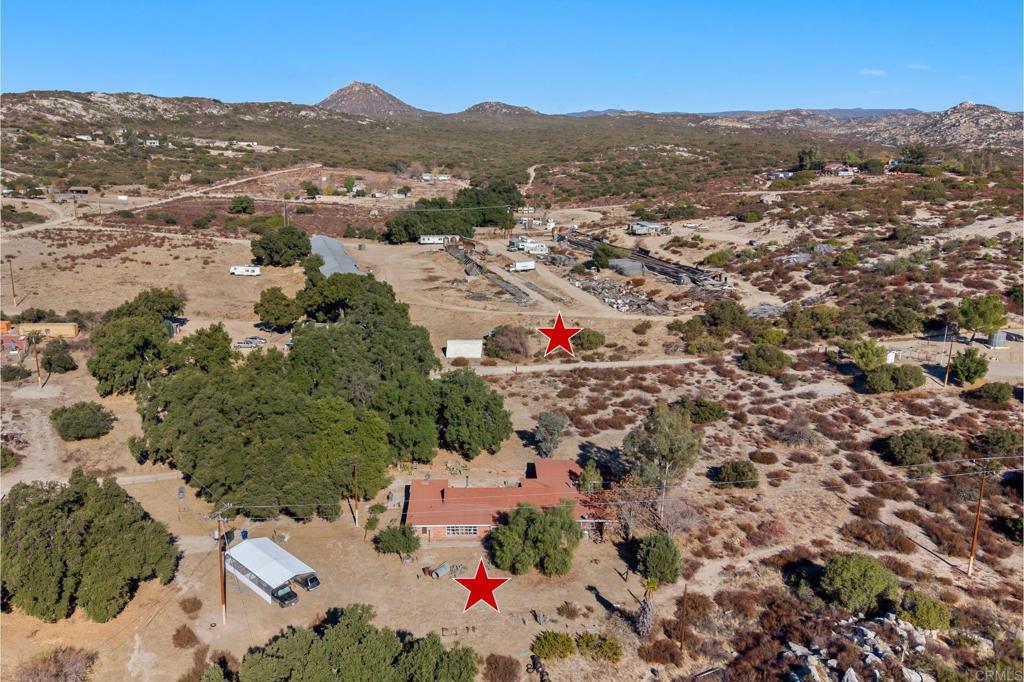 ENDLESS OPPORTUNITIES NESTLED UPON 7 ACRES! This rare offering includes two parcels being sold together. The main house 6.25 Acre lot, plus an additional 0.75 acre parcel (APN: 607-130-02-00) - providing space, privacy, and potential to expand your dream home. Court Approved Probate Sale - Cash Only. This 4 bedroom, 2 bath cosmetic fixer is nestled within seven combined acres of breathtaking views, it presents a unique opportunity for those with a vision of creating their dream home. Mature oaks and meadow areas. Property is on well and propane. Lots of parking, extra storage, chicken coop, and so much more. Located in a peaceful and private setting, this property offers the perfect canvas for a personalized oasis. You can restore the existing structure or design your own dream home from scratch. Plenty of room on property for an ADU as well. The attached garage was converted into storage with a workshop. Quick drive to top rated schools (Campo Elementary School and Mountain Empire High School), fire station, Morena Lake, Cleveland National Park, Railroad Museum & amenities. Grab your imagination and don’t miss out on this excellent opportunity!