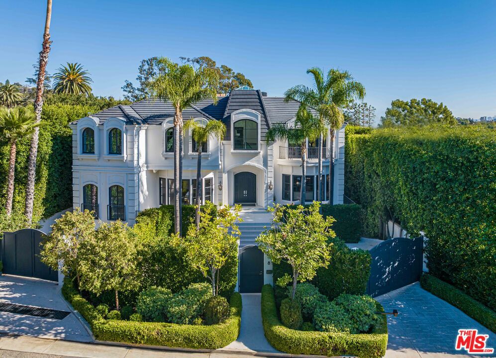Introducing 8 Oakmont, an unparalleled residence nestled on one of Brentwood Park's most exclusive palm-lined streets. This monumental estate offers a sublime living experience, showcasing meticulous design and an unwavering commitment to excellence. Step into the awe-inspiring marble foyer, illuminated by a soaring skylight, leading to a grand staircase that gracefully separates the formal living and dining rooms. Modern kitchen seamlessly aligns with the home's design ethos, characterized by flowing spaces fostering a tranquil ambiance with views of the Getty Museum. The rounded edges echo throughout the family and living areas, extending to the private outdoor oasis, complete with a lushly landscaped garden and a captivating swimming pool. The estate features 8 bedrooms, each with spacious ensuite bathrooms and expansive closets. The primary suite is a haven with dual bathrooms and an adjoining nursery equipped with a mini kitchen. Additional amenities include a six-car attached garage, staff quarters, an elevator, basement, gated entry, designer lighting, a butler's pantry, a media/entertaining room, a sauna, offices, and more. Conveniently located near the best schools in Southern California. Don't miss this rare opportunity to own a premier residence on the highly sought-after Oakmont Drive. Also available for lease at $55,000/Month.