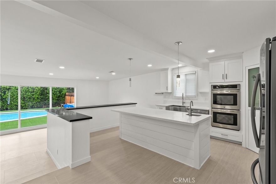 Stunning Modern Remodel with Pool, Spa & Flexible Studio Space
Beautifully remodeled contemporary home in North Hills with designer upgrades throughout. Featuring smooth-coated walls, fresh interior/exterior paint, and brand-new light-colored laminate flooring, this home offers modern comfort and style. The open-concept kitchen includes white shaker cabinets, quartz countertops, stainless steel appliances, and a large island that anchors the space. All bathrooms have been fully renovated with premium finishes, custom tile work, and modern fixtures. Washer and dryer included.

The backyard is a private resort-style retreat with new turf landscaping, a sparkling swimming pool, spa, and a newly finished patio ideal for outdoor dining and relaxation.

A standout feature is the ADU-style bonus studio with its own newly remodeled bathroom showcasing marble-style tile and brass fixtures, plus a kitchenette with shaker cabinetry, cooktop, microwave, and refrigerator. This versatile space is perfect for an office, studio, etc.

Conveniently located near Granada Hills and Porter Ranch to the North, Encino and Sherman Oaks to the south with easy access to the 405 and 118 freeways, this turn-key property delivers contemporary living, functional versatility, and exceptional outdoor amenities.