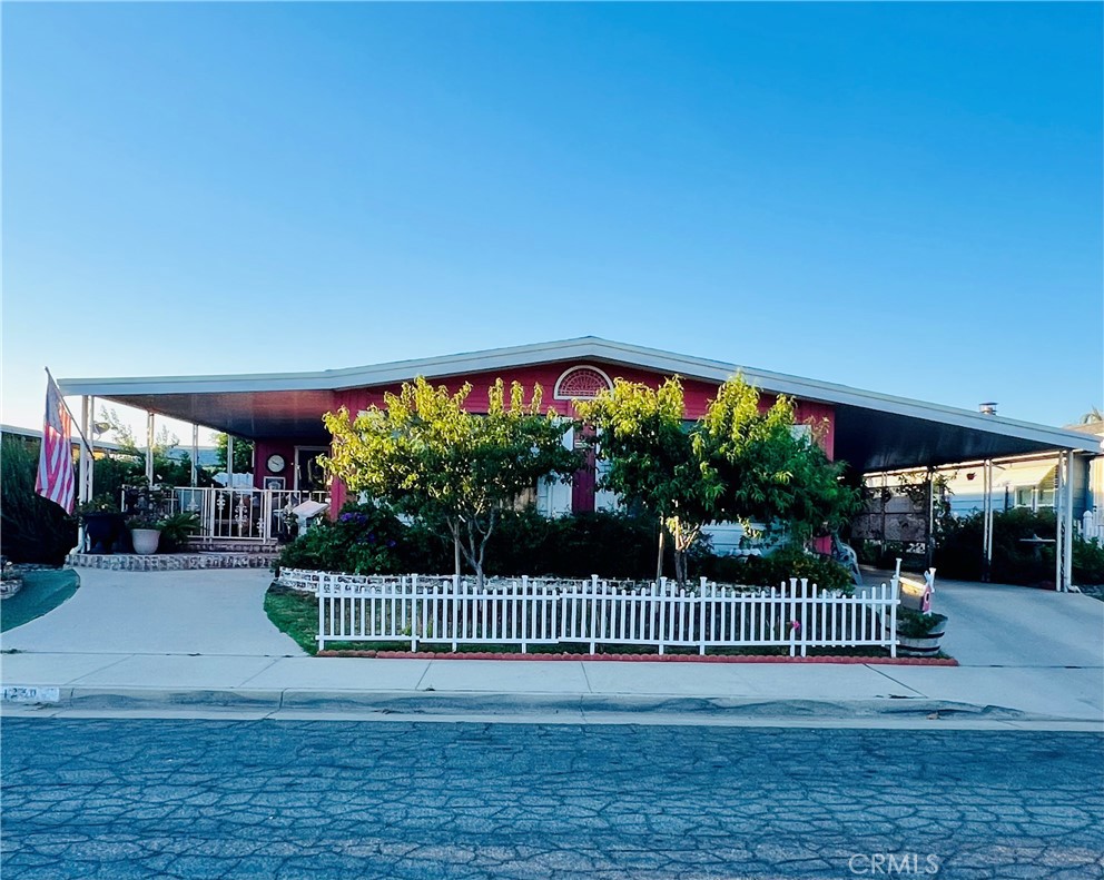 Welcome to Sierra Dawn North Estates, a 55+ community, where you own your land! Enjoy a private oasis with this bright and airy 2 bed 2 bath home plus a bonus room.
Outside you’ll find an abundance of fruit trees and an enclosed back porch where you can enjoy the shade of the trees or spend time gardening in your own private garden. Property includes orange, lemon, and peach trees.
Entering from the enclosed front porch you’ll step into a cozy living room with an electric fireplace and dining room with built in hutch that leads into the open concept kitchen and family room with a second electric fireplace.
The home also features a good sized primary bedroom with private en-suite, a second bedroom and bathroom as well as a laundry room. The home also features a large bonus room that could be used as an office or potential third bedroom.
Filled with natural light, privacy, and no HOA this home is a must see.